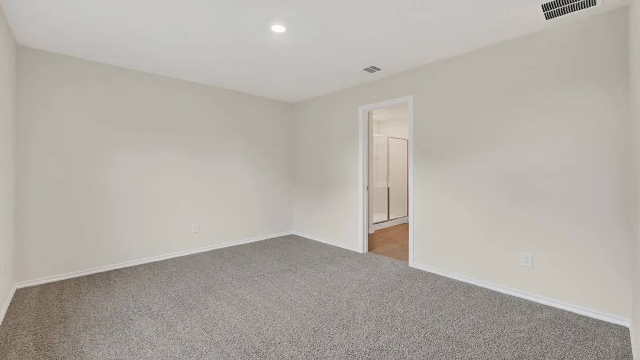 Recessed lighting, light-toned walls, and grey carpeting