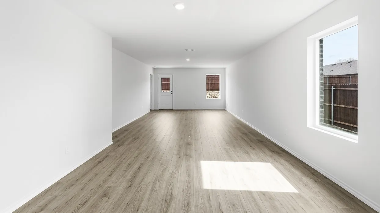 Spacious room featuring wood-finish flooring, recessed lighting, and multiple windows