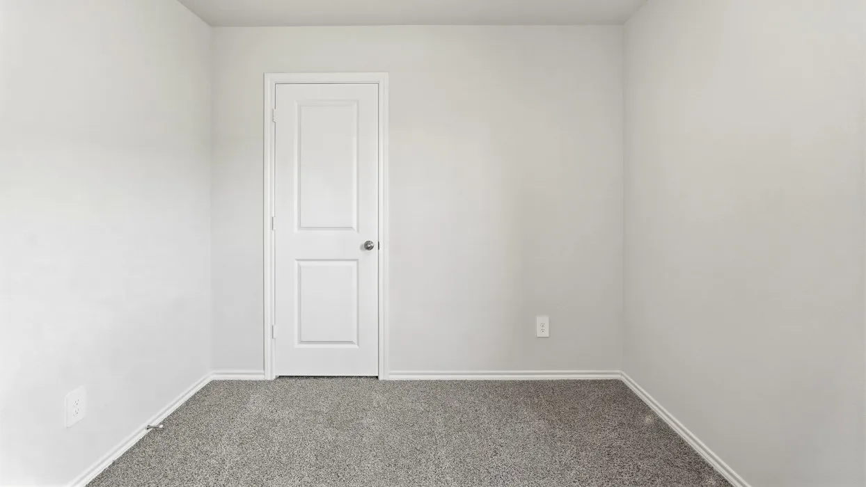 Plush carpeting, light-toned walls, and a white two-panel door