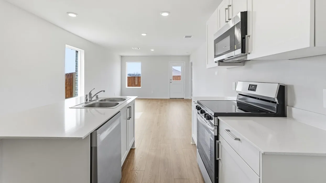 Kitchen featuring white cabinetry, stainless steel appliances, white countertops, and recessed lighting