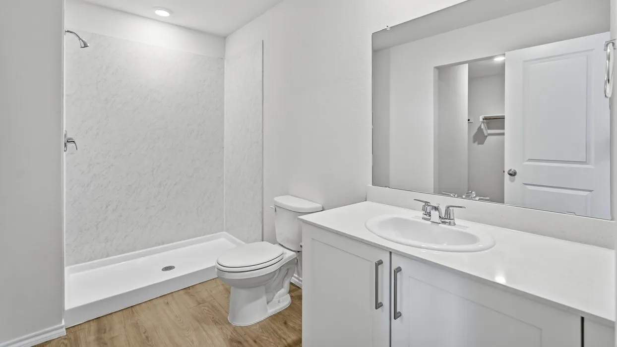 White bathroom vanity with an integrated sink, polished chrome faucet, and quartz​​‌​​​​‌​​‌‌​‌‌​​​‌‌​‌​‌​‌​​​‌​​ countertop