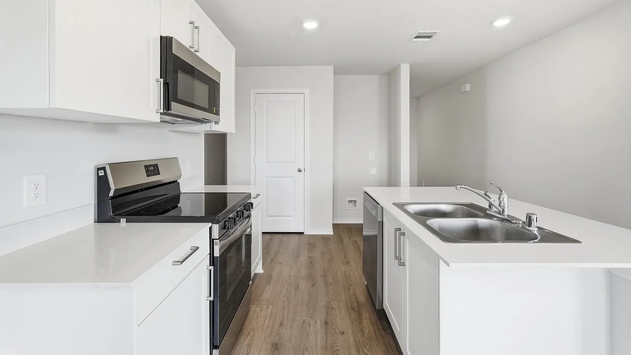 Bright kitchen featuring white cabinetry, stainless steel appliances, wood-finish flooring, white countertops, and recessed lighting