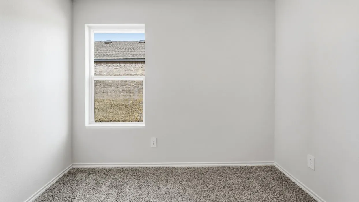 Light gray textured walls, gray carpeting, and a white-framed window