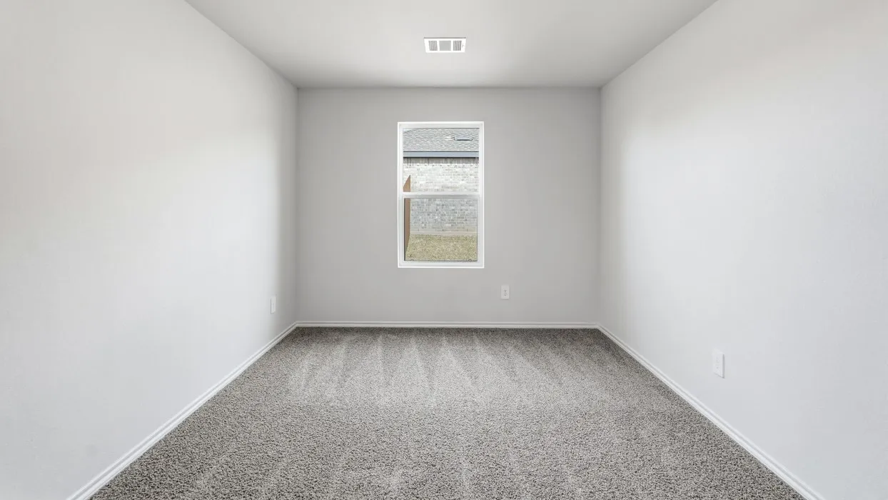 Neutral-toned walls, carpeted flooring, and a single window