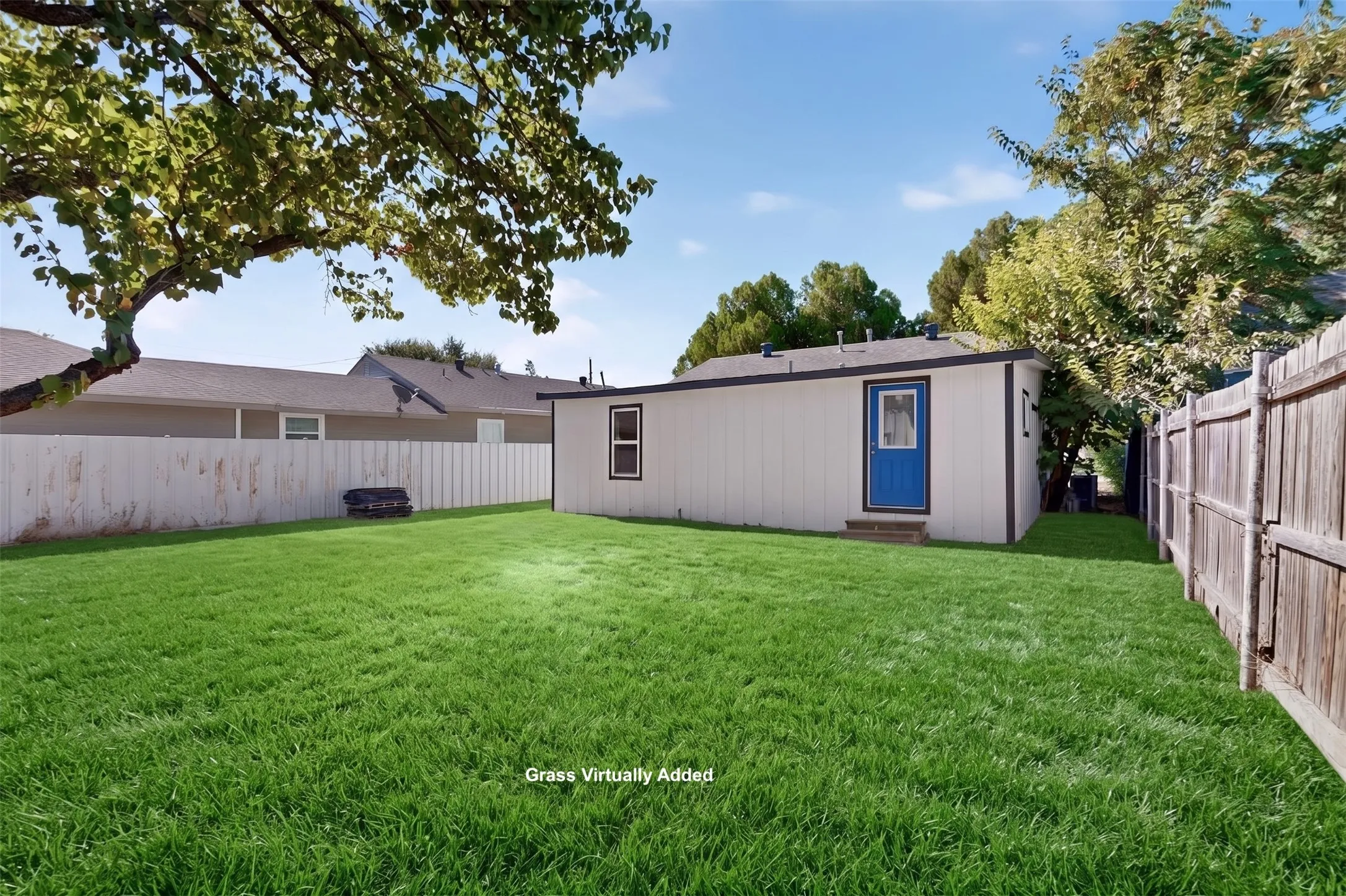 Detached structure with a blue door, white siding, and dark trim