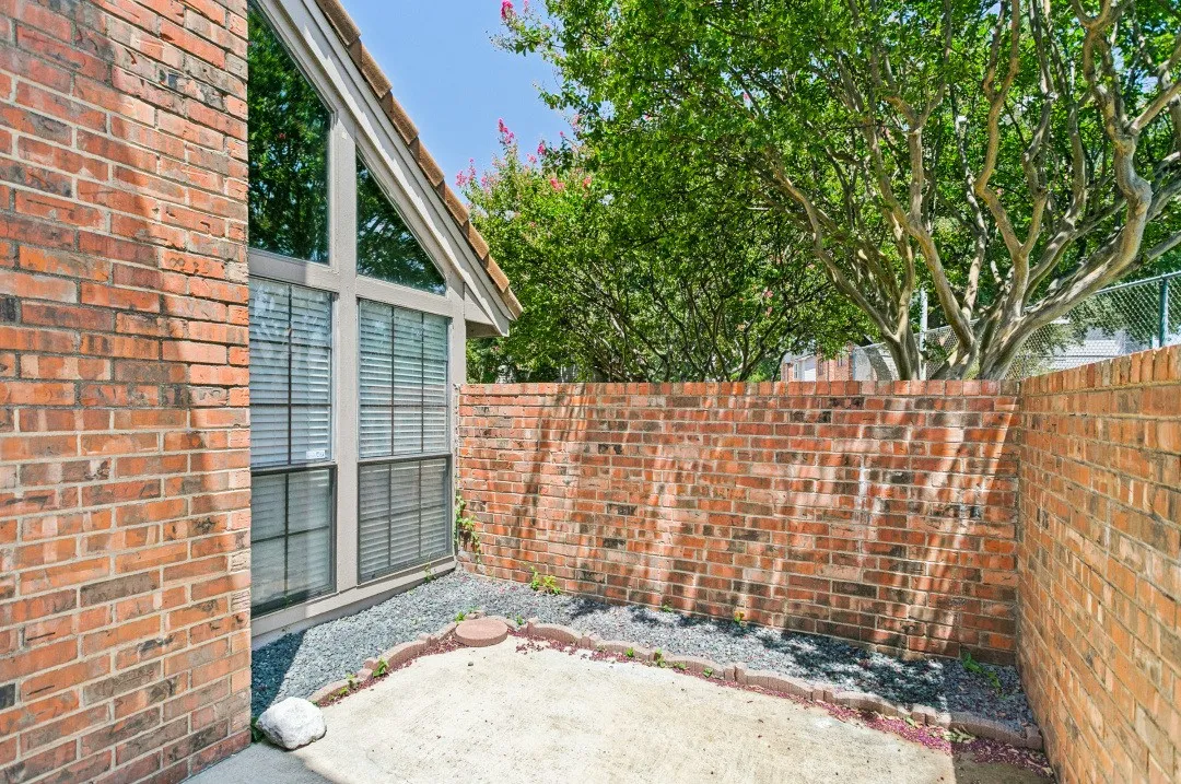 Brick exterior with an angular window design, featuring multiple window panes