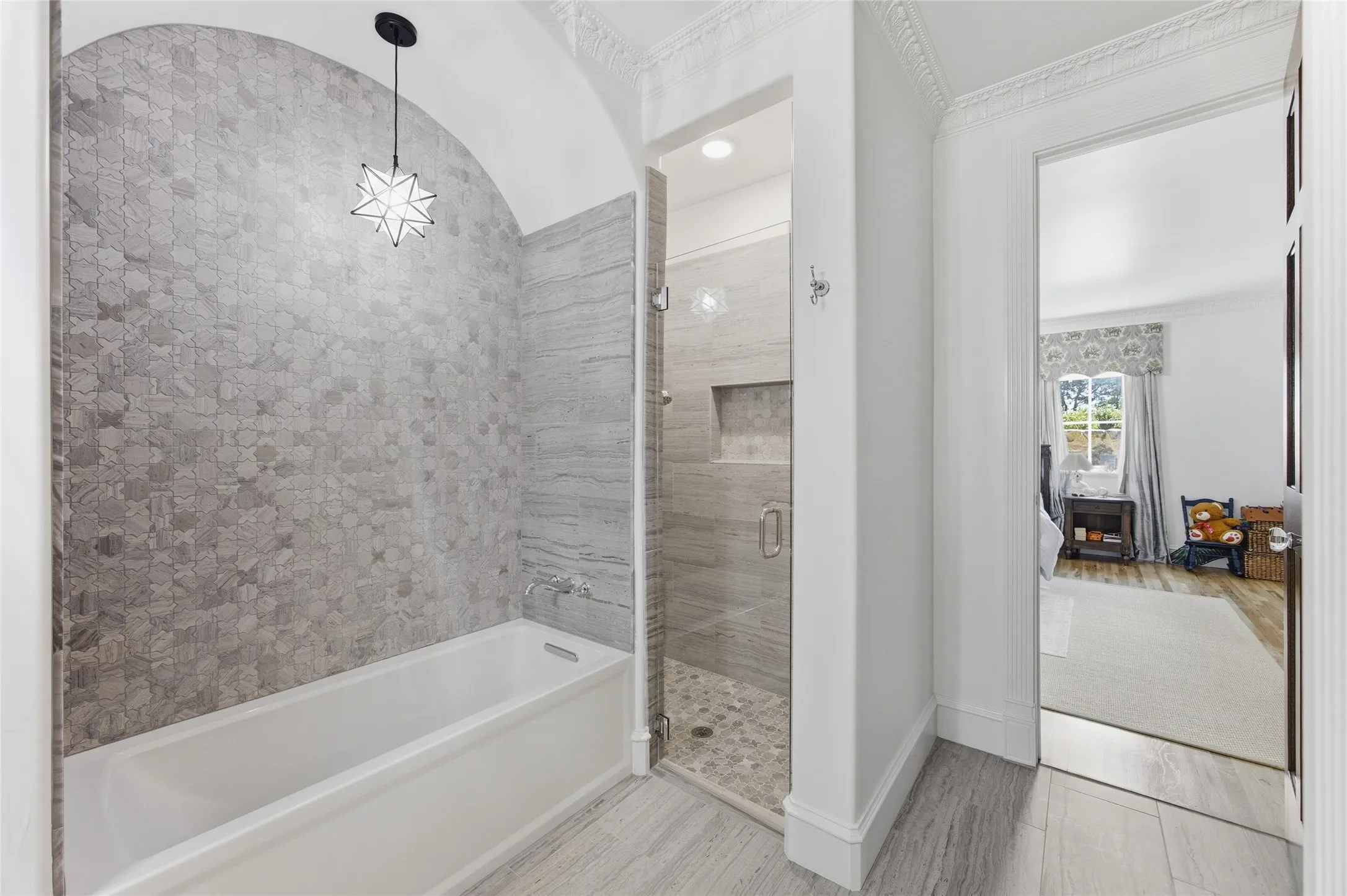 Bathroom featuring a built-in bathtub, a walk-in shower with a glass enclosure, patterned wall tile, and stone-finish flooring