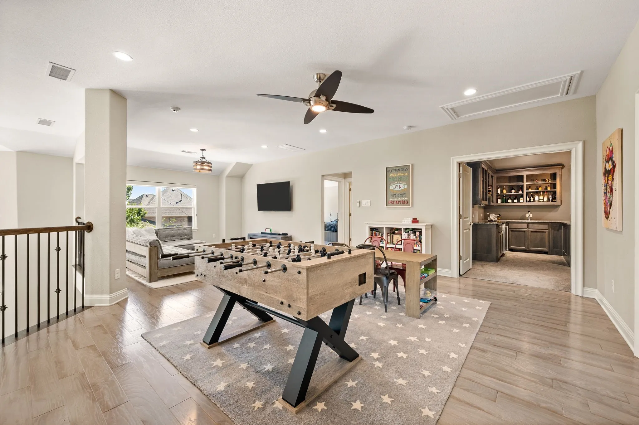 Expansive bonus room with wood-finish flooring, recessed lighting, and a ceiling fan