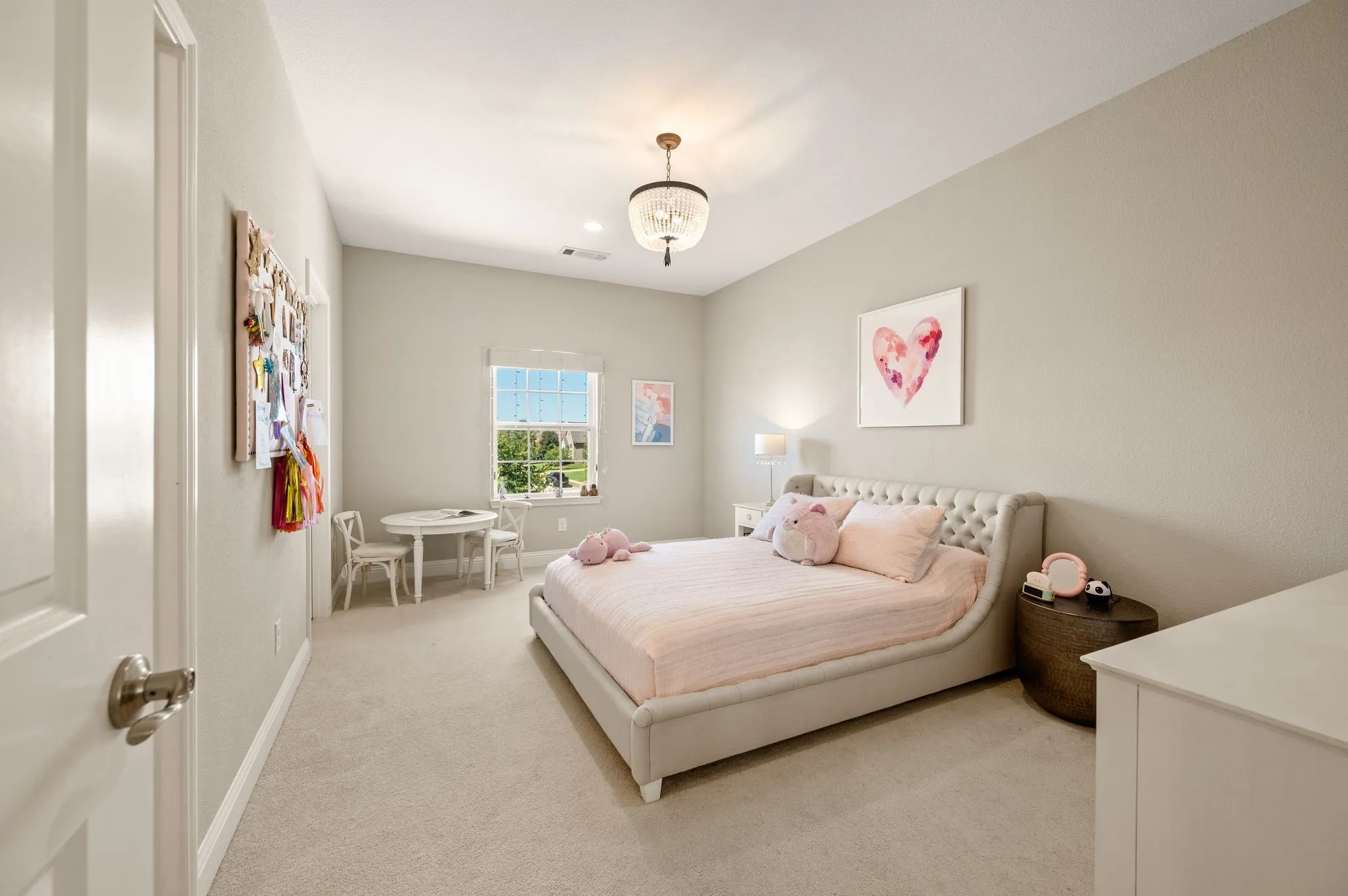 Serene bedroom retreat offering neutral wall finishes, carpeted flooring, and abundant natural light from a large window