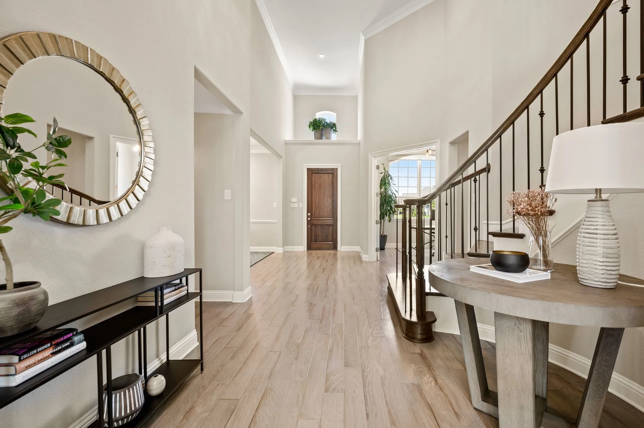 Bright Entry featuring wood-finish flooring, white painted walls, and abundant natural light from multiple windows