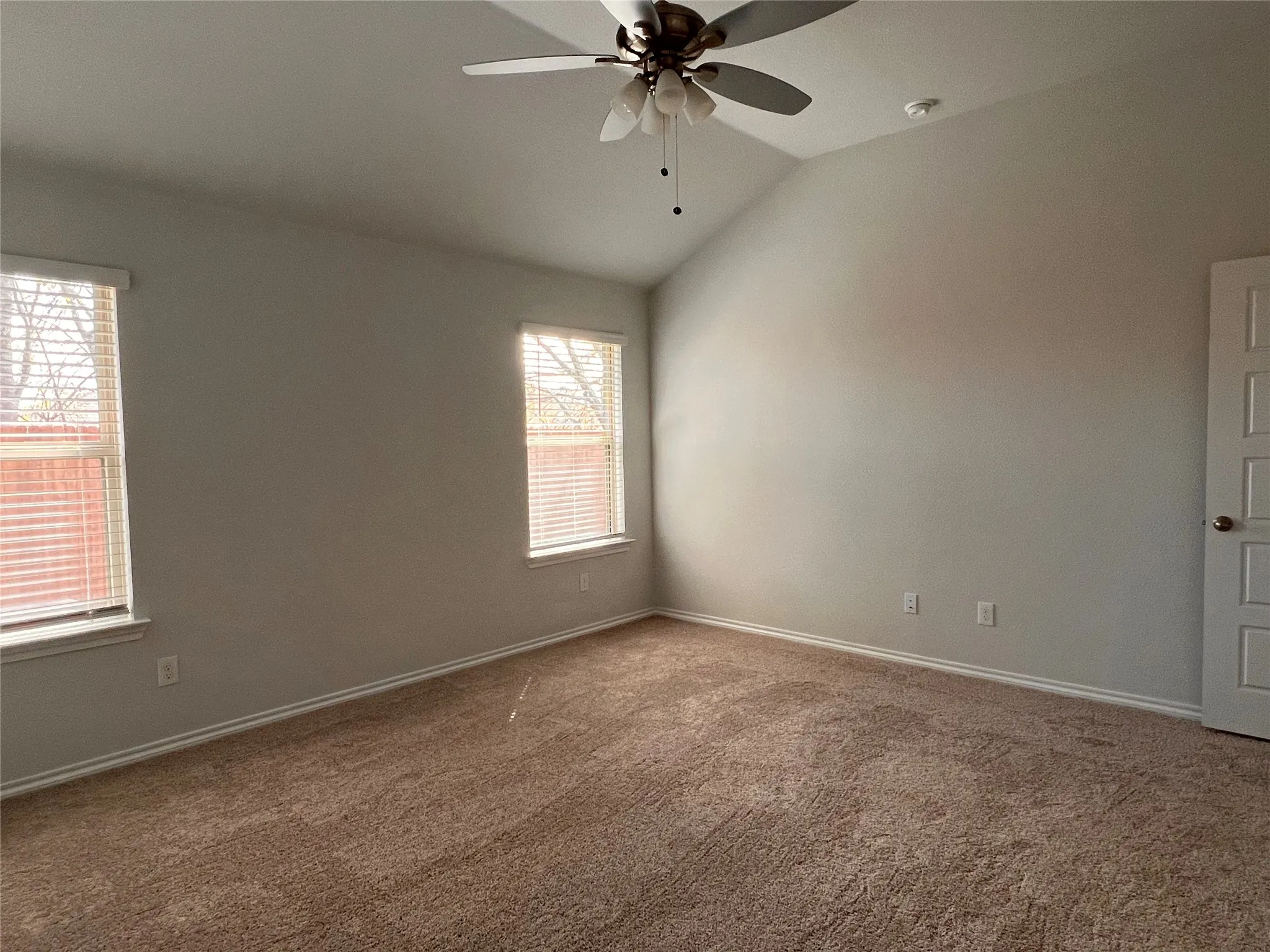 Primary bedroom from door to bathroom.