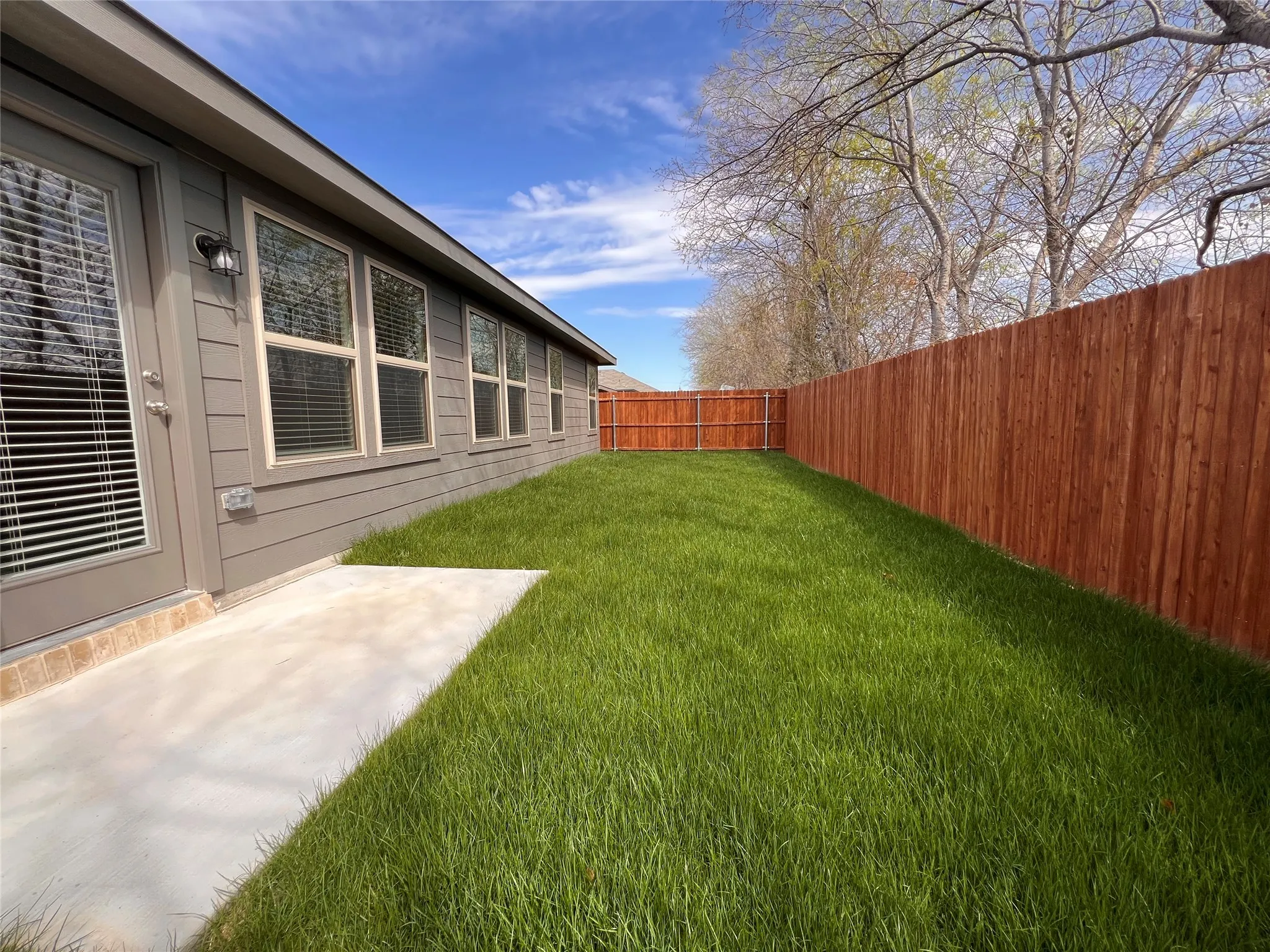 Back yard has small patio space.
