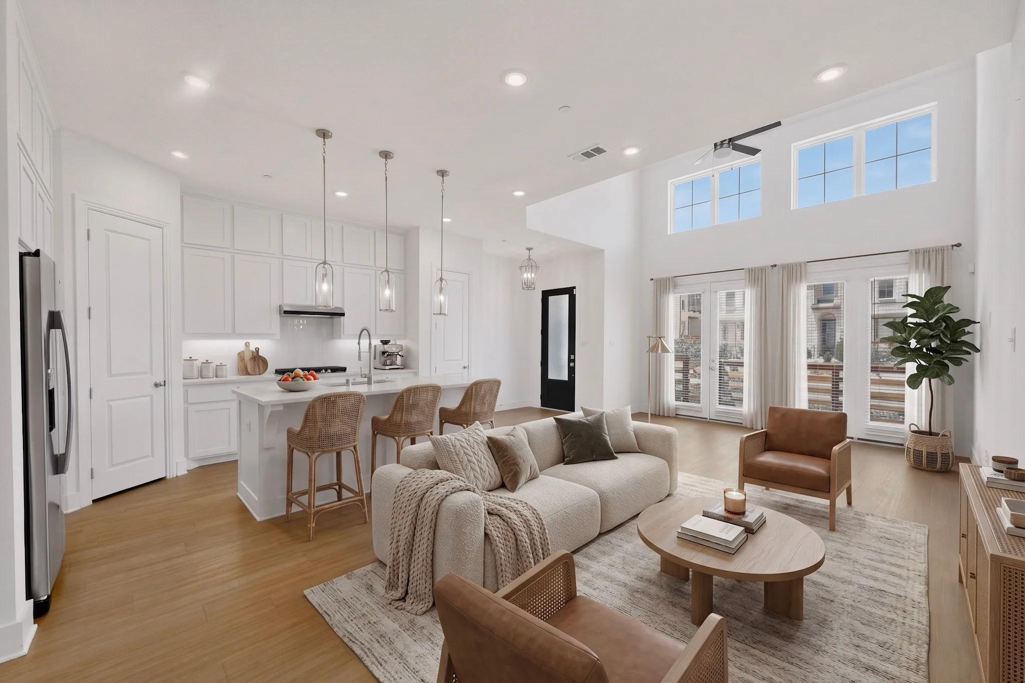 Vaulted ceilings, wood-finish flooring, white cabinetry, stainless steel appliances, and large windows