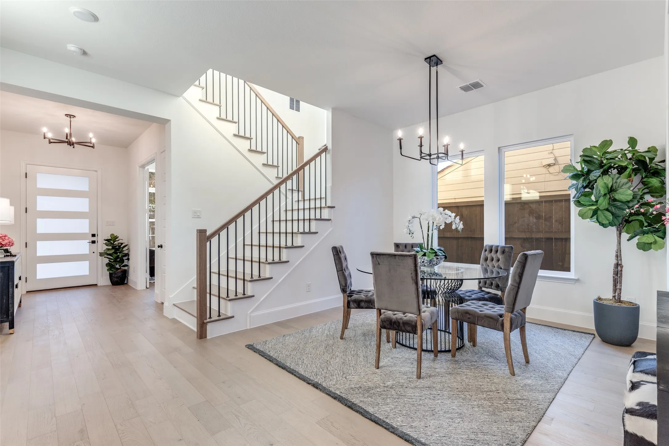 Breakfast/Dining area featuring a chandelier, stairway, plenty of natural light, and light wood-style flooring