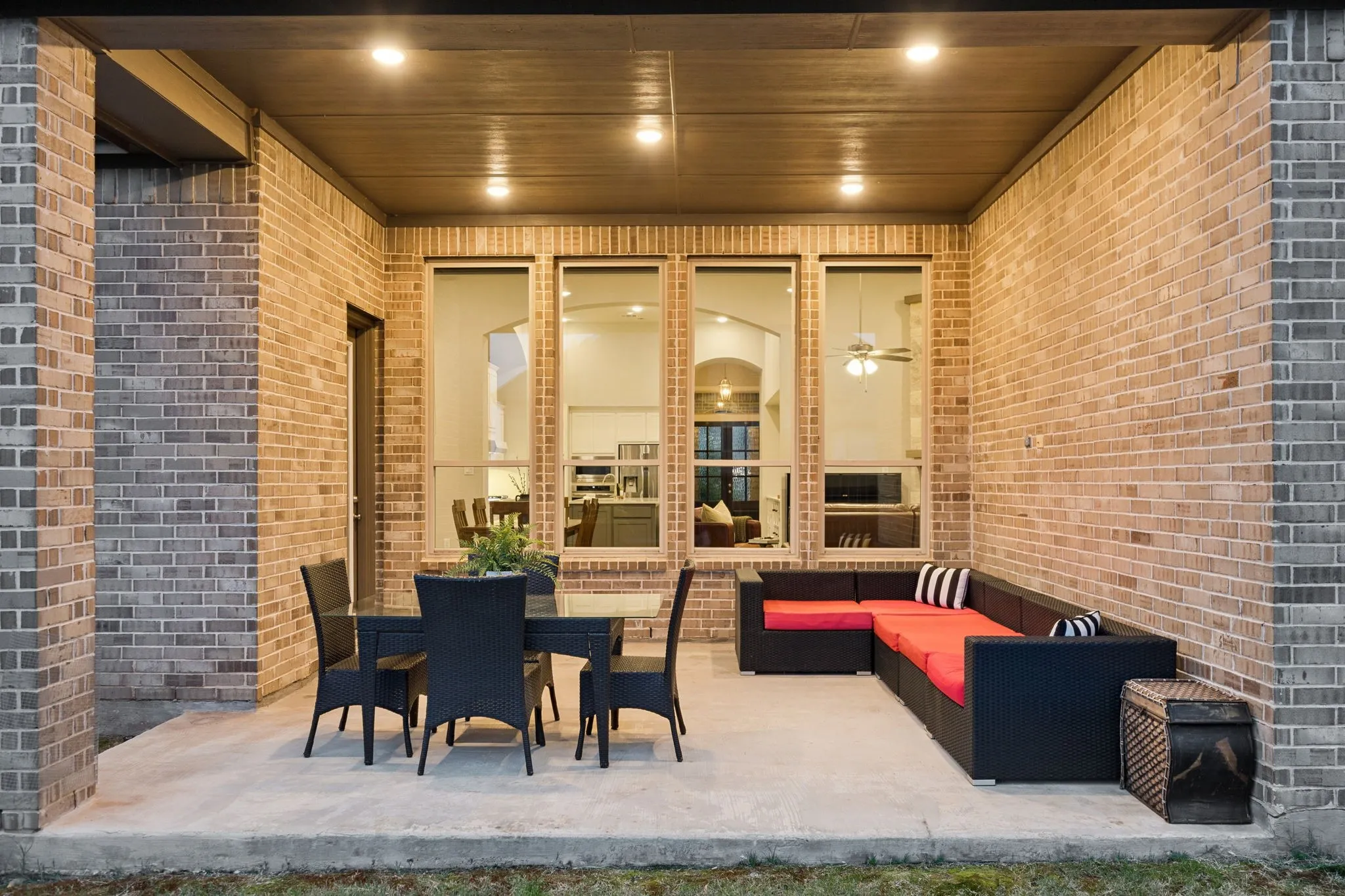 Covered patio with a concrete slab, recessed lighting, and brick exterior walls