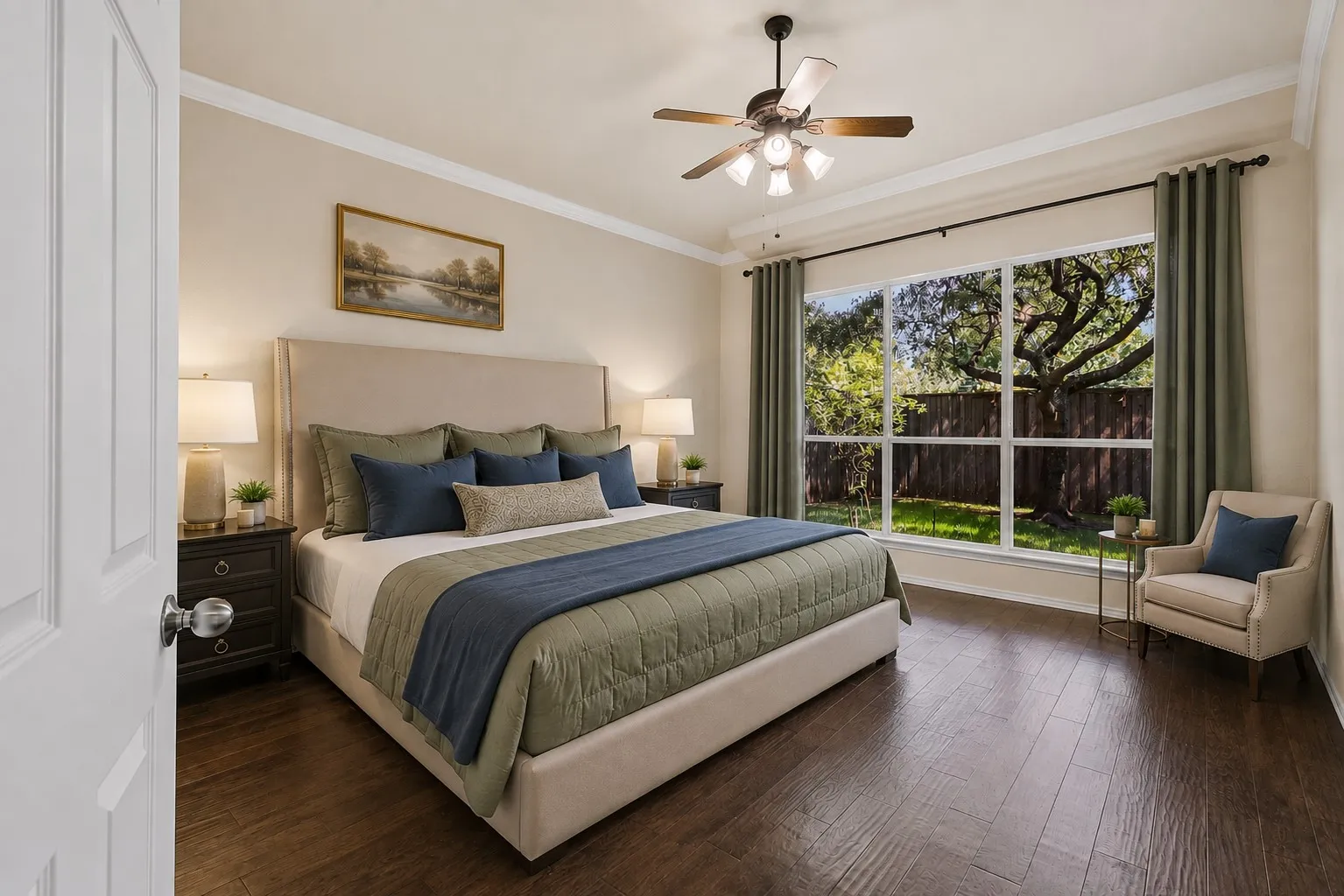 Hardwood-look flooring, large picture window, crown molding, and a ceiling fan with integrated lighting