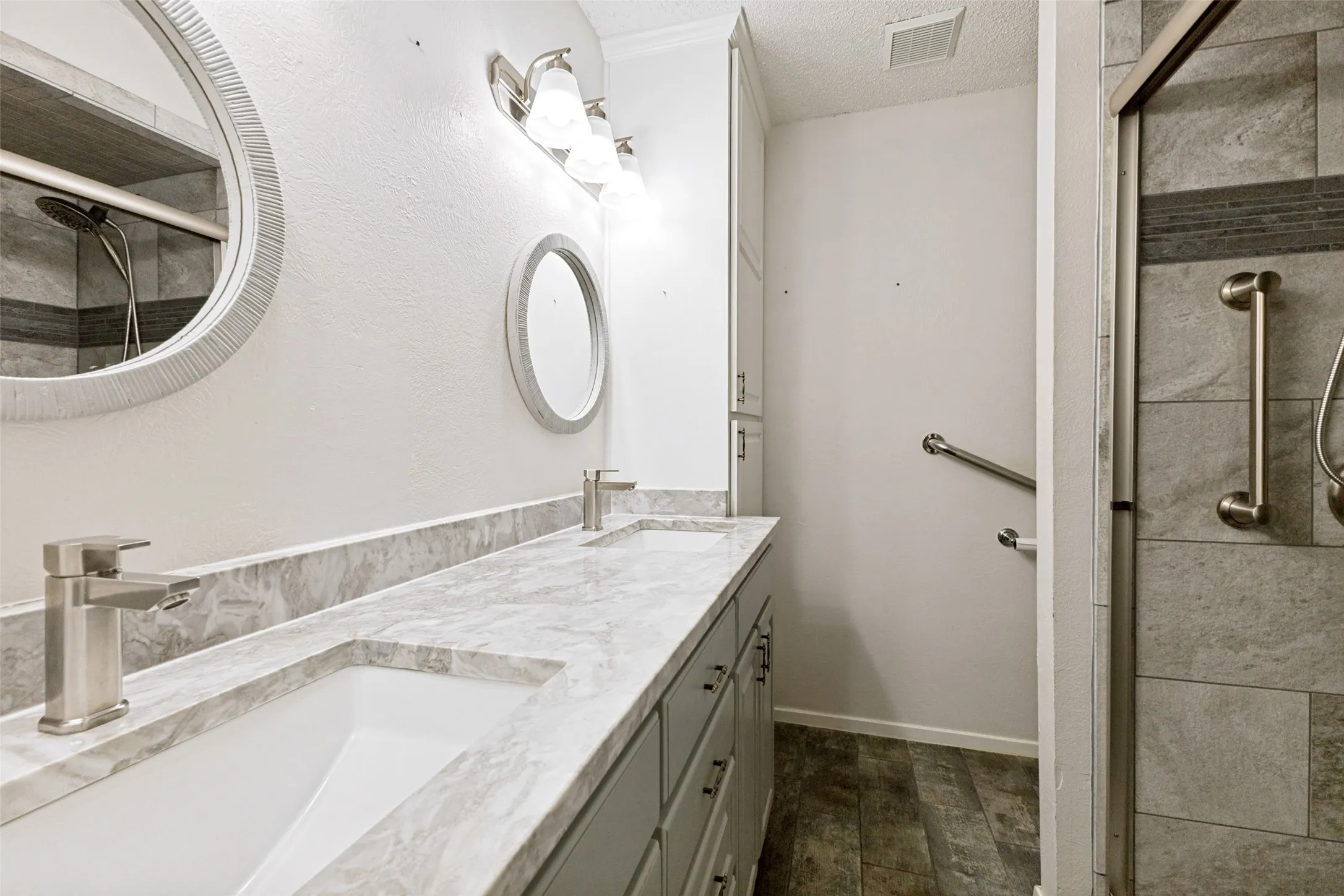 Updated hall bath quartz countertops & tiled walk-in shower