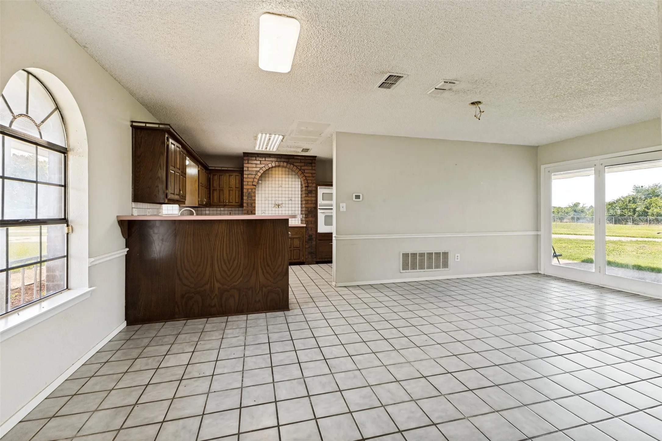 Spacious dining area with floor to ceiling glass & door access to the patio (2nd home)