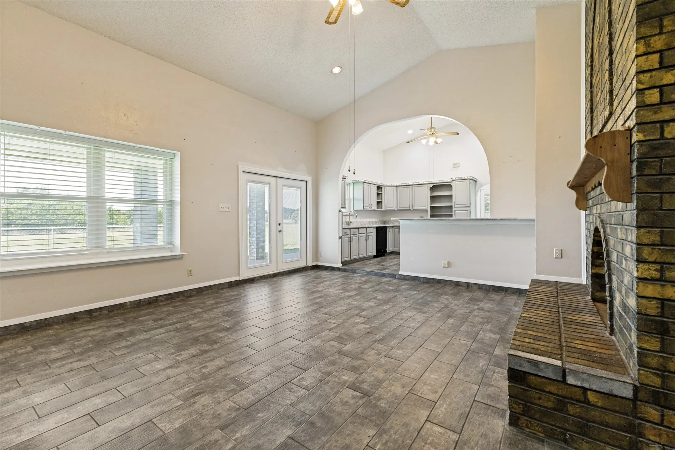 Vaulted ceiling & wood burning fireplace in family room