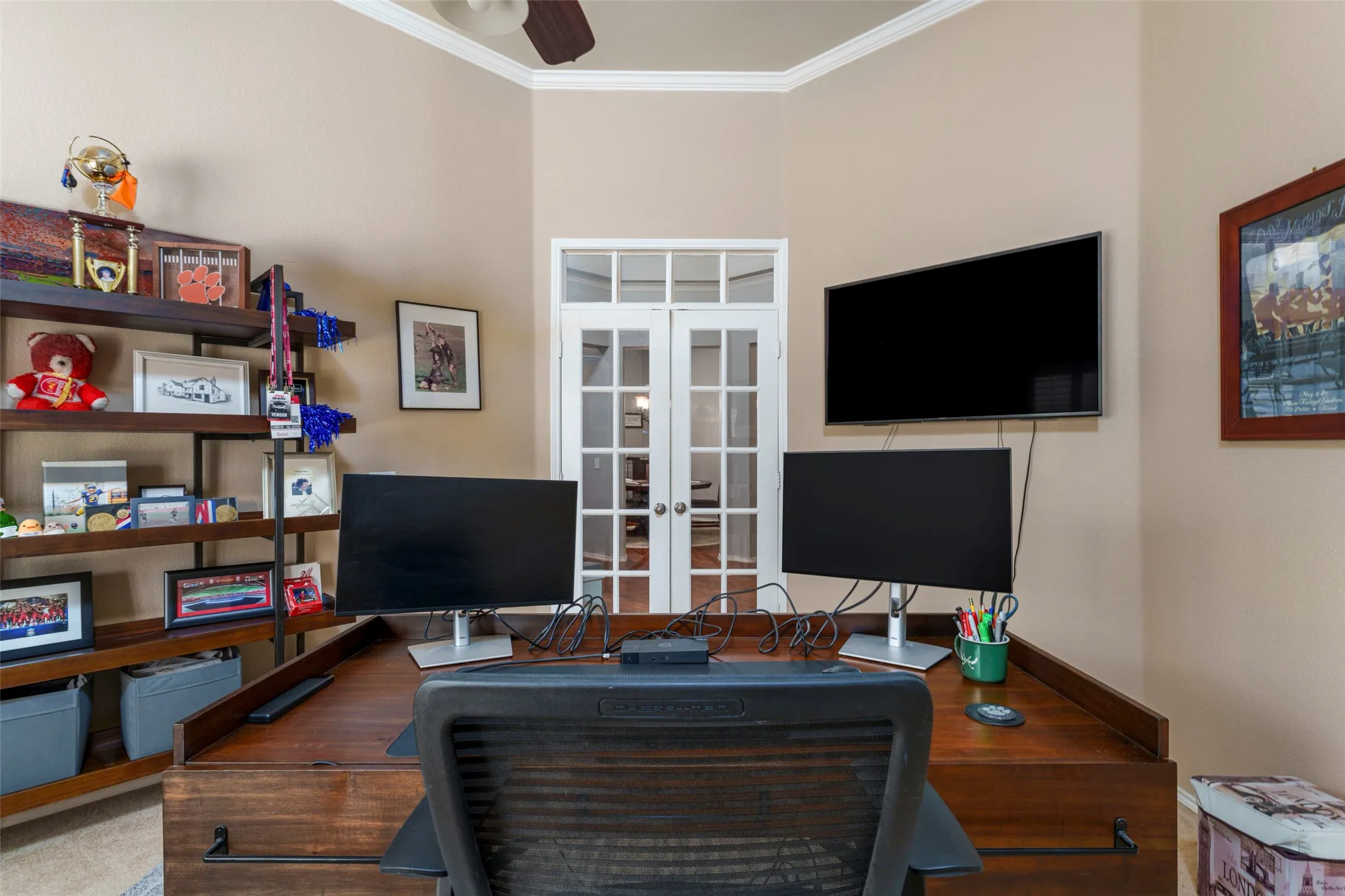 Room featuring crown molding, neutral wall color, and a ceiling fan