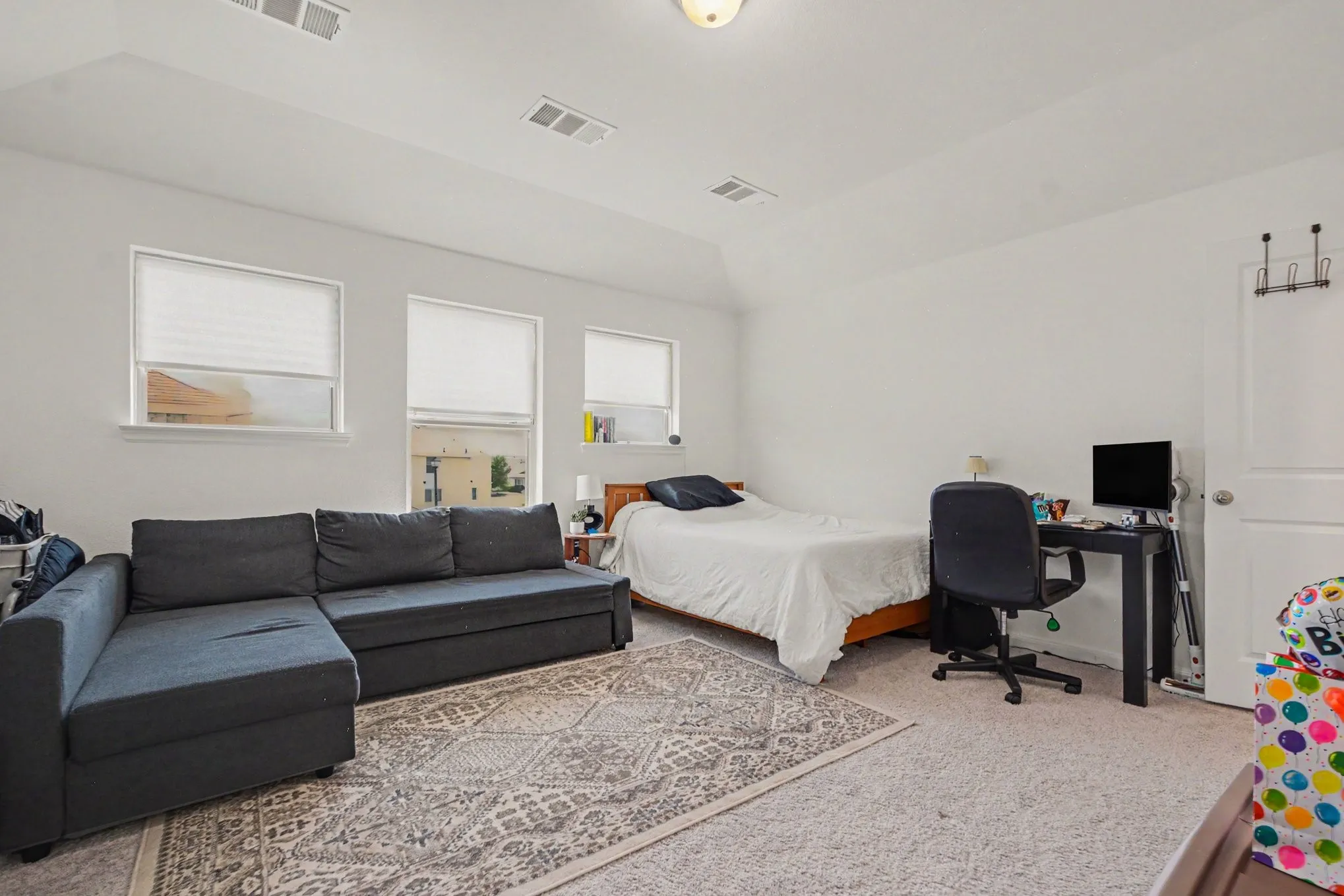 Recessed lighting, three windows, and white walls