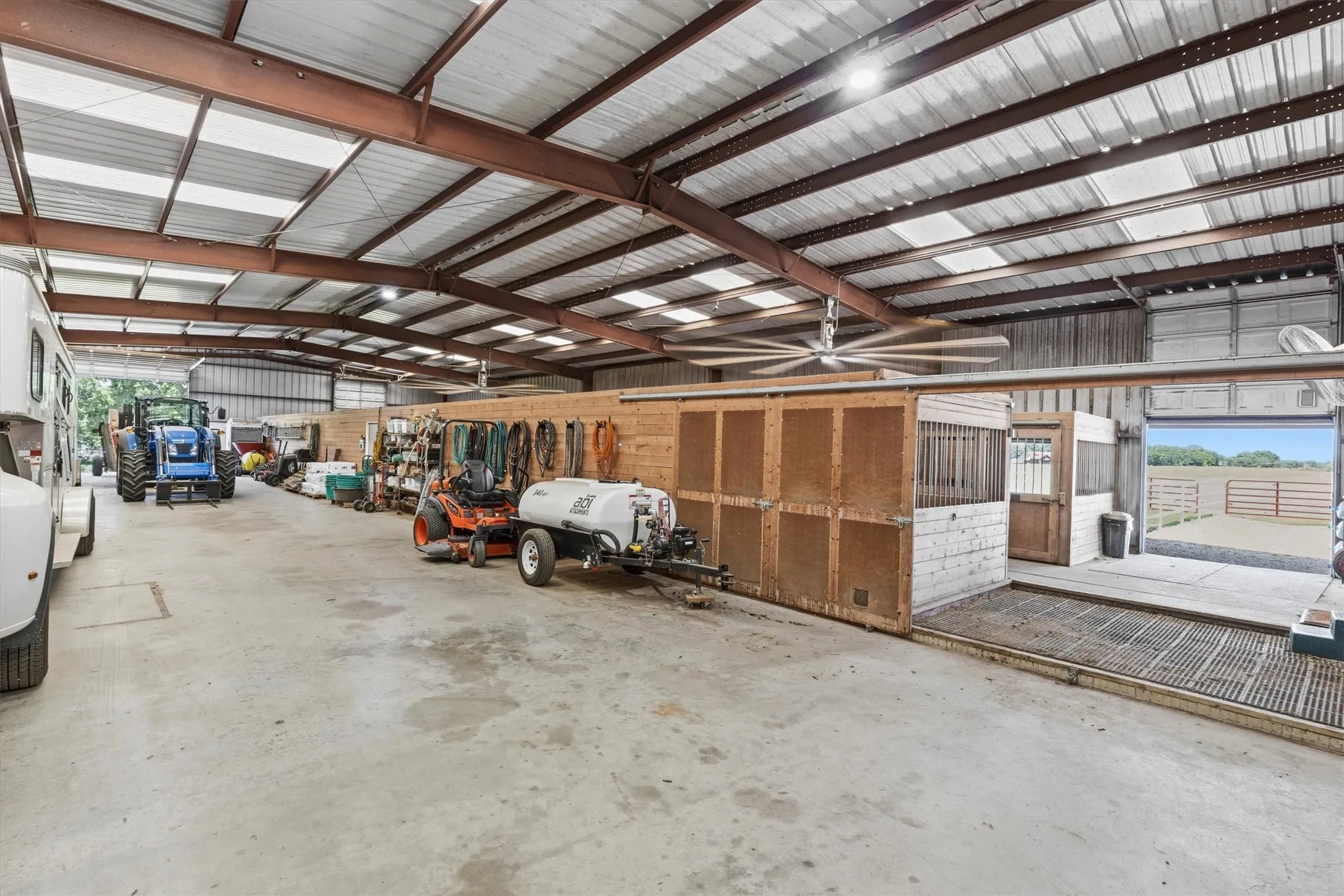 Expansive metal-framed structure with a corrugated metal roof and translucent skylight panels