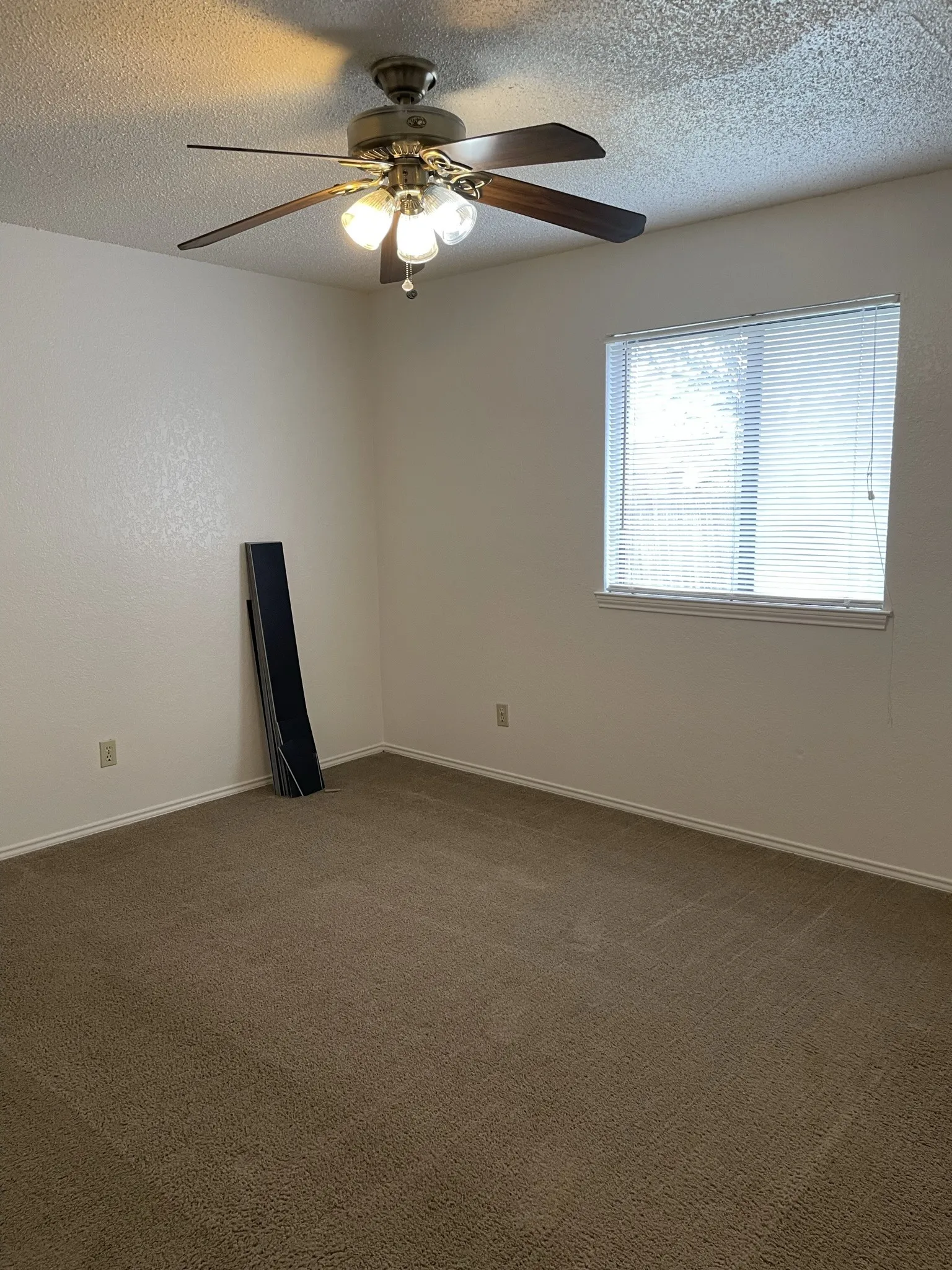 Neutral-toned wall paint with a textured ceiling finish