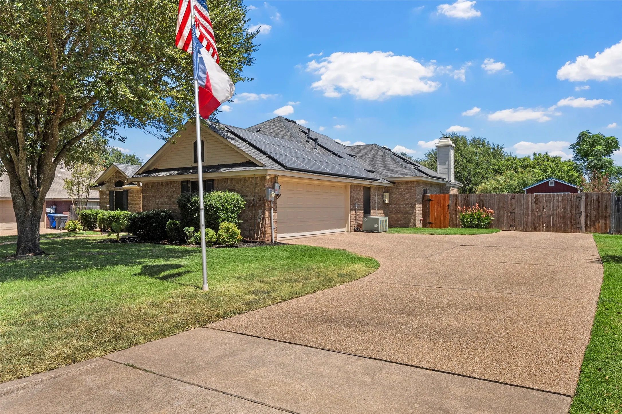 Brick exterior with a gabled roof and solar panels