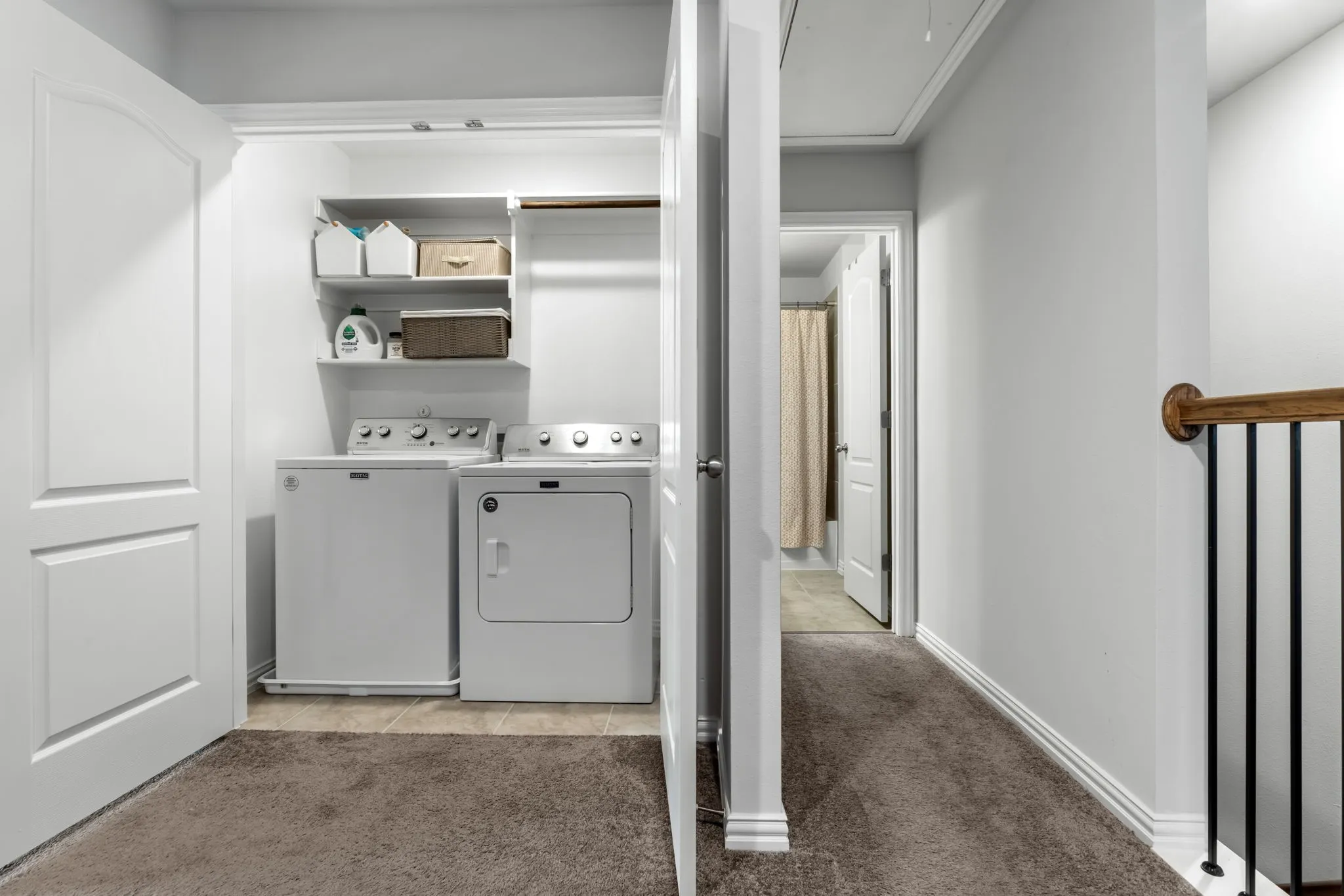 Built-in laundry closet with shelving and hanging rod