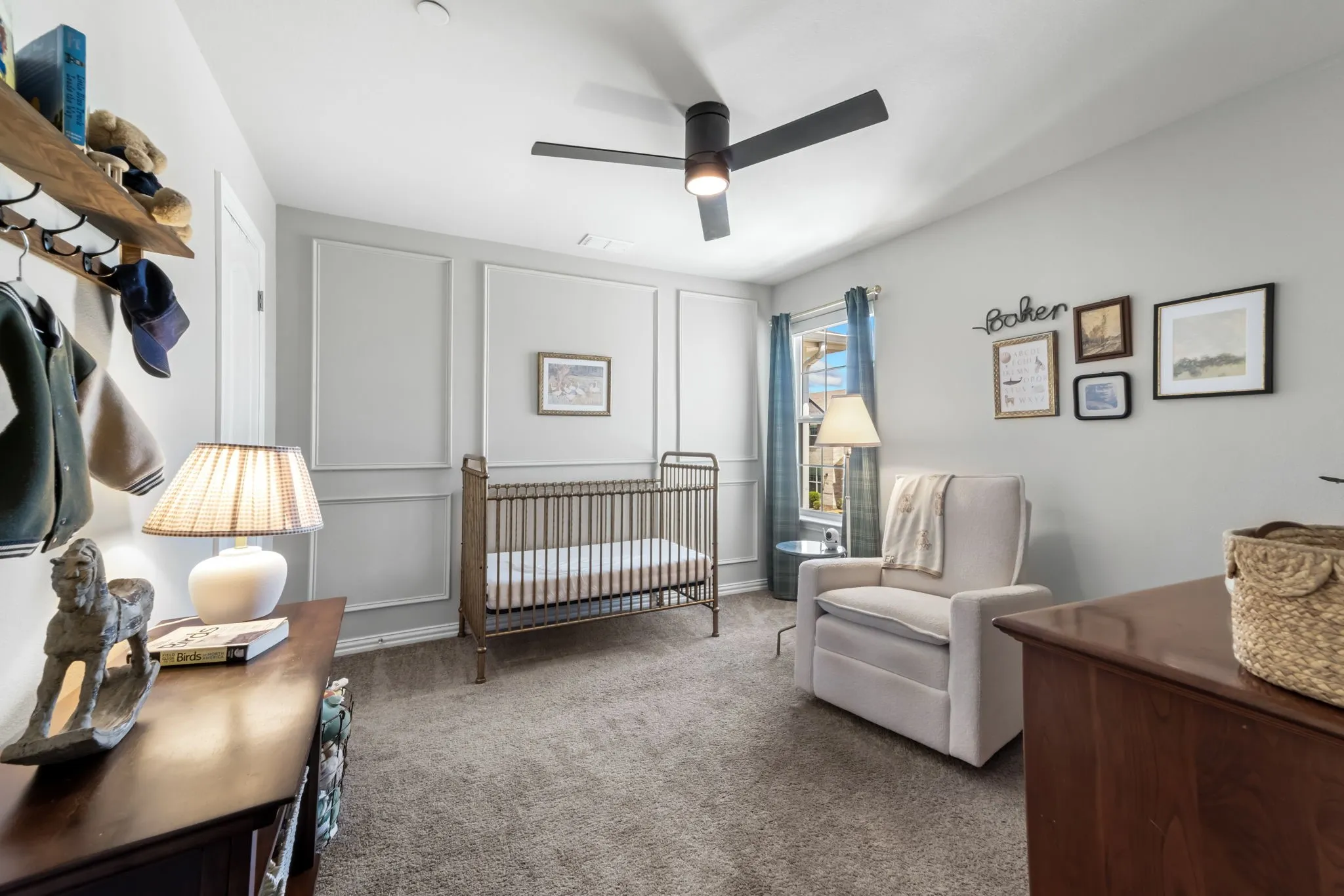 Recessed lighting, ceiling fan, carpet flooring, decorative wall molding, and a window with curtains