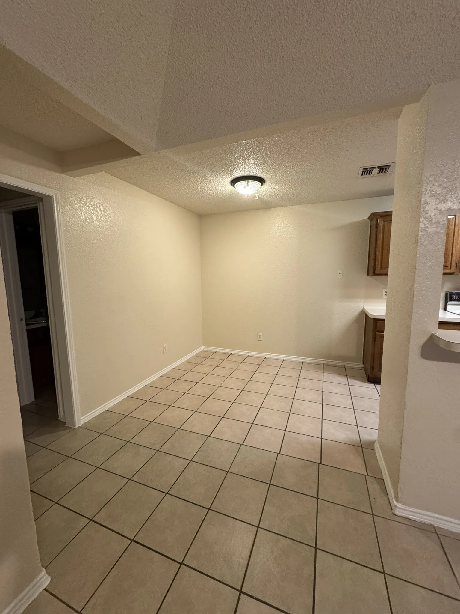 Tile flooring, recessed ceiling design, and a flush-mount ceiling light fixture