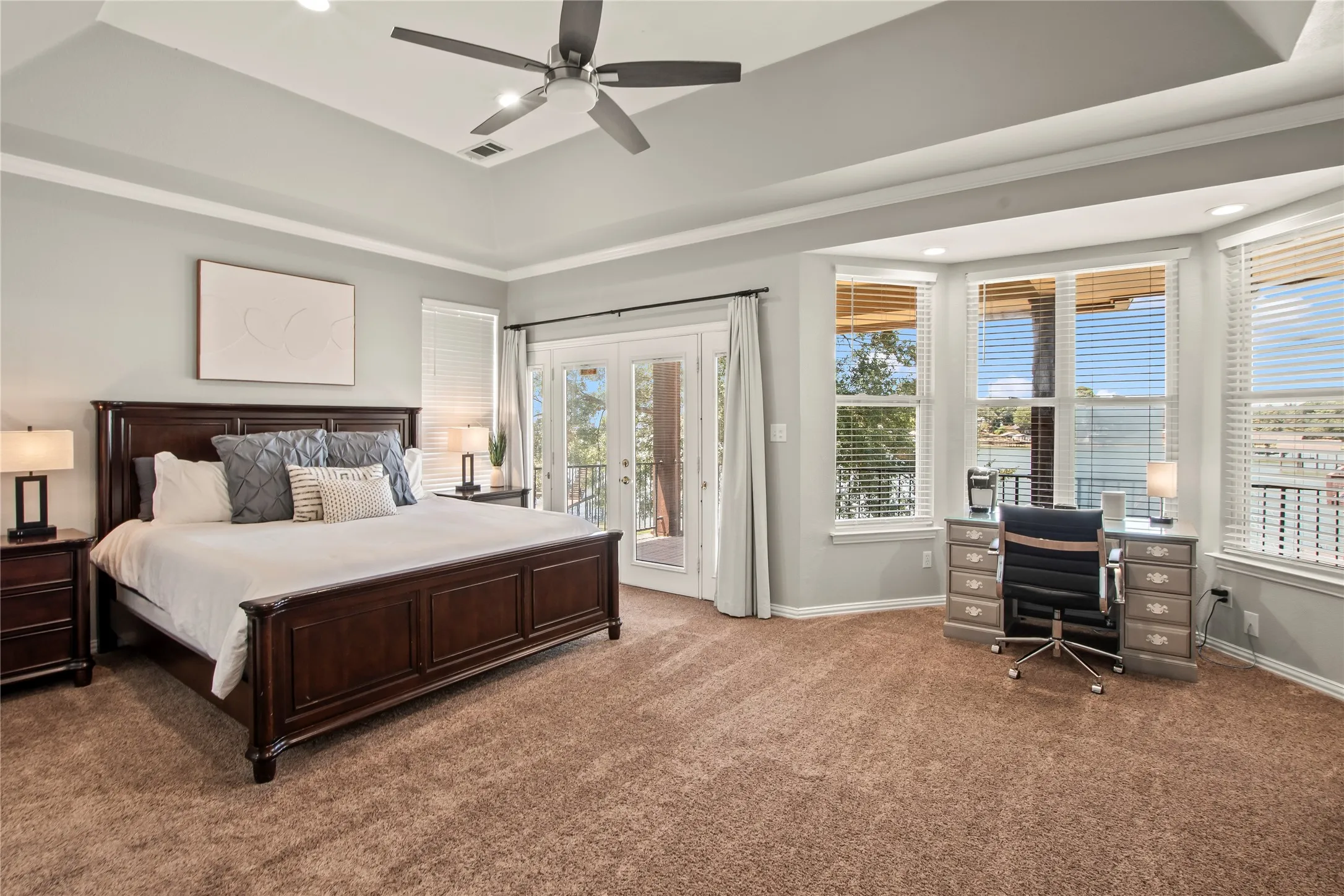 Primary ensuite bedroom with balcony access and lovely water views to wake up to!