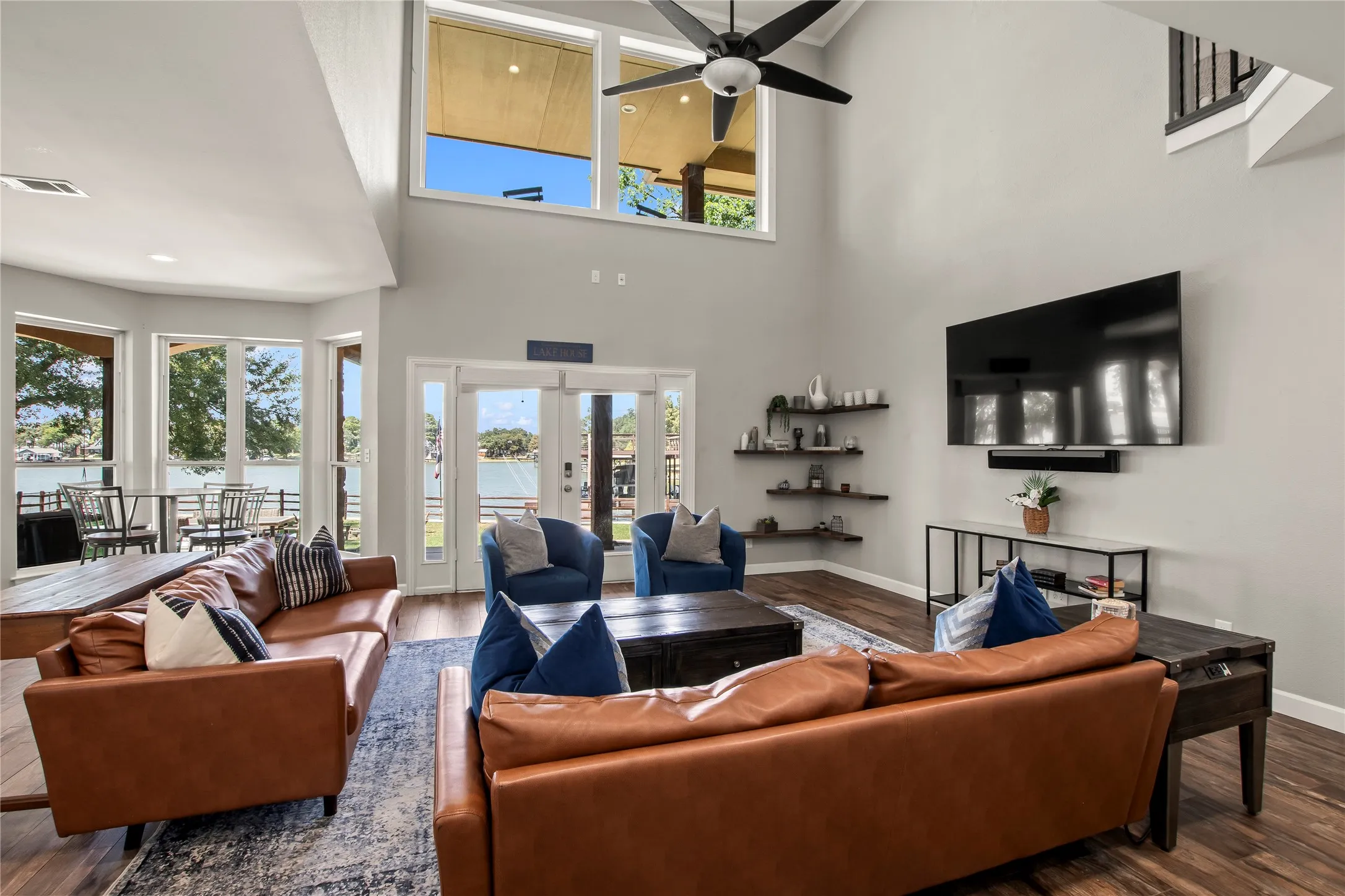 Soaring ceilings, wood look tile floor and lots of glass showcasing nice water views.