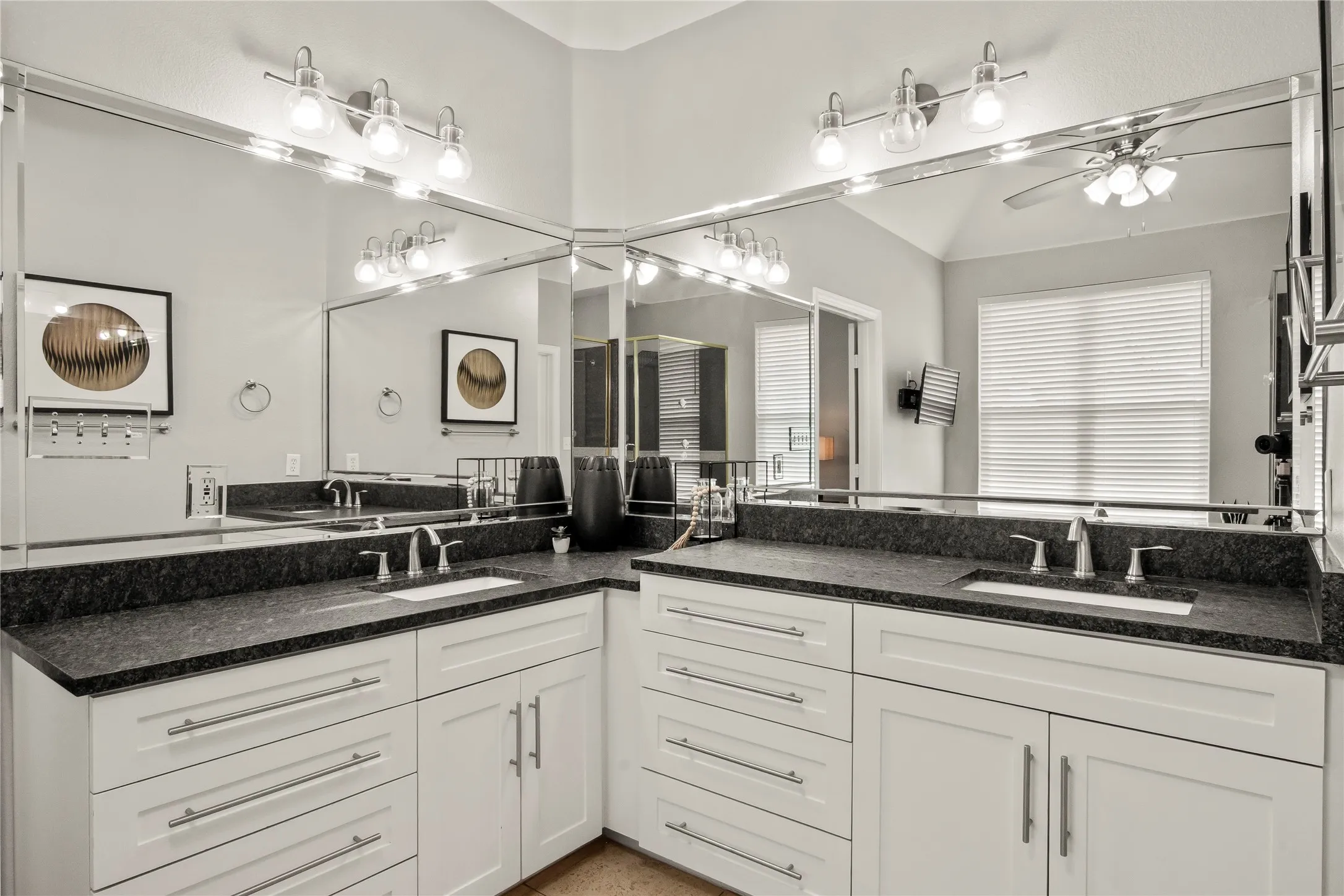 Ensuite primary bath with double sink vanity with leather granite counter tops.n