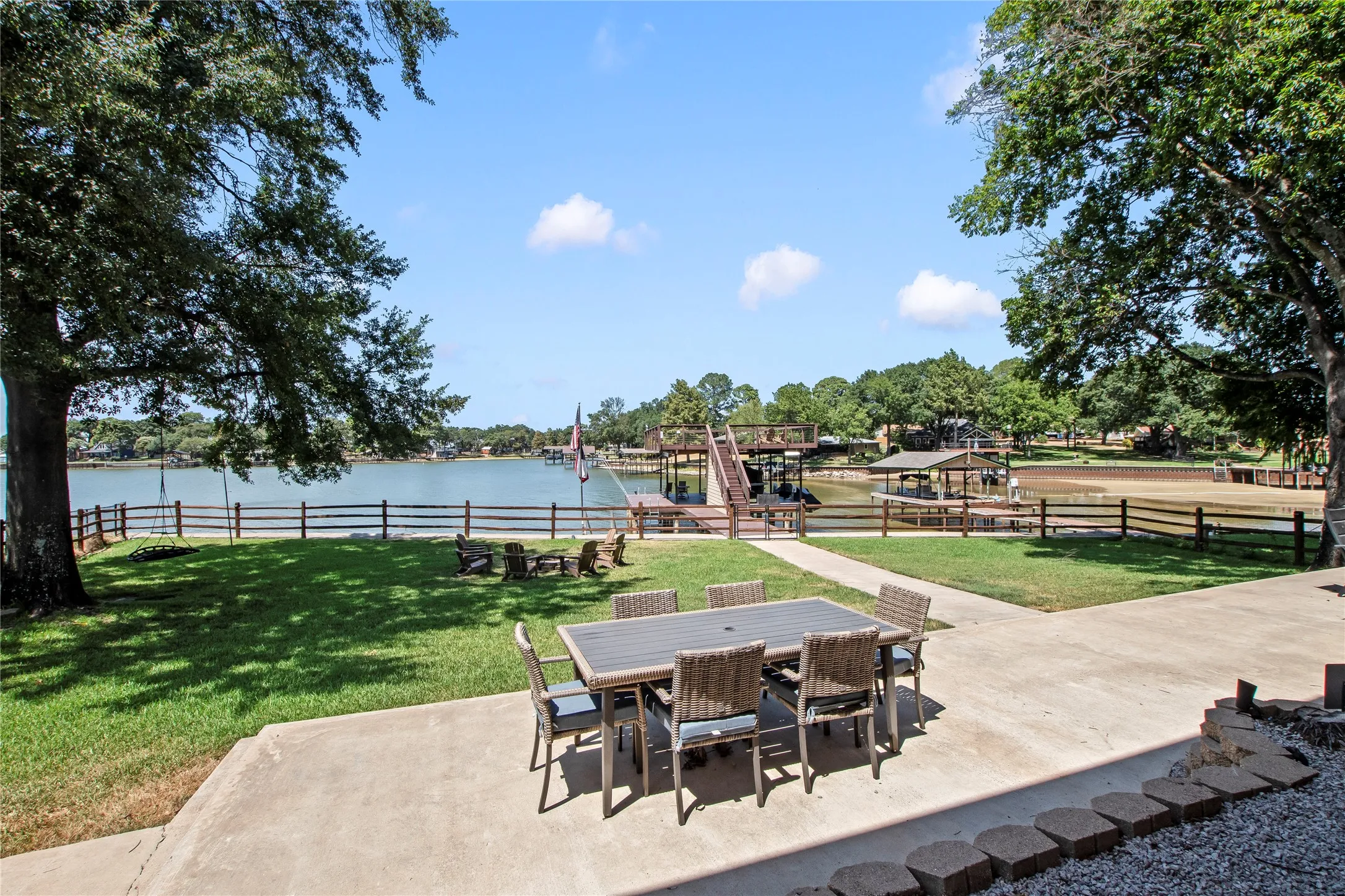 Spacious covered and uncovered patios overlooking large fenced yard with firepit.