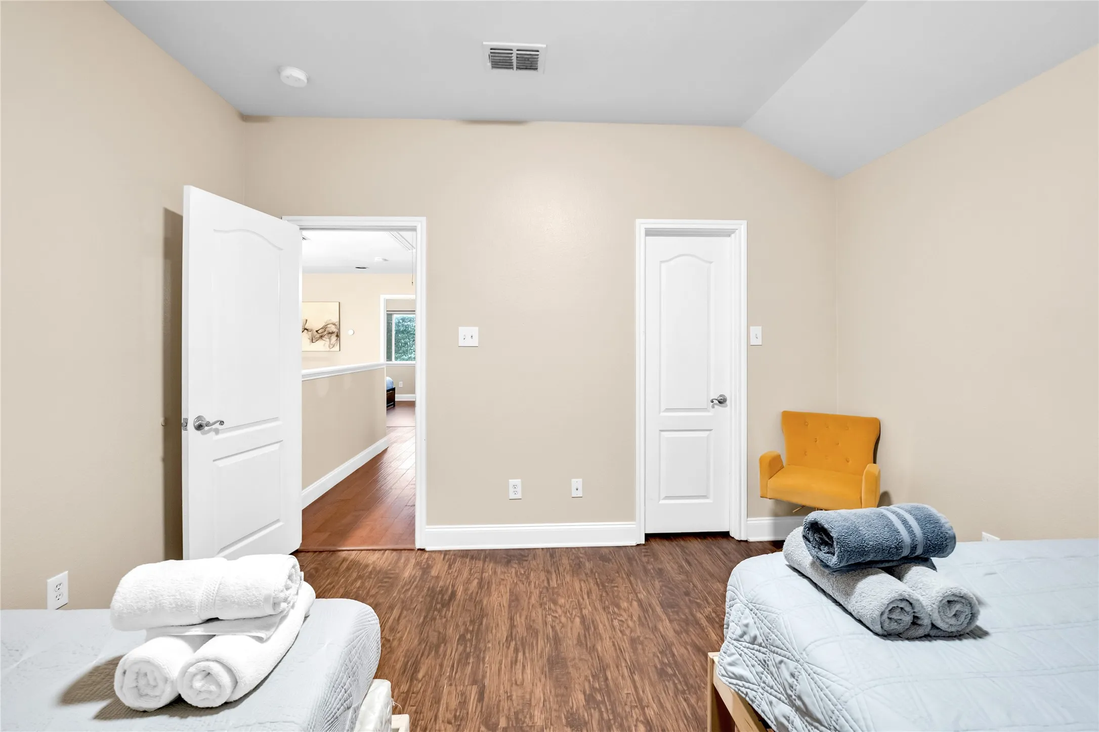 Wood-finish flooring throughout, white interior doors with contemporary hardware, and neutral wall tones