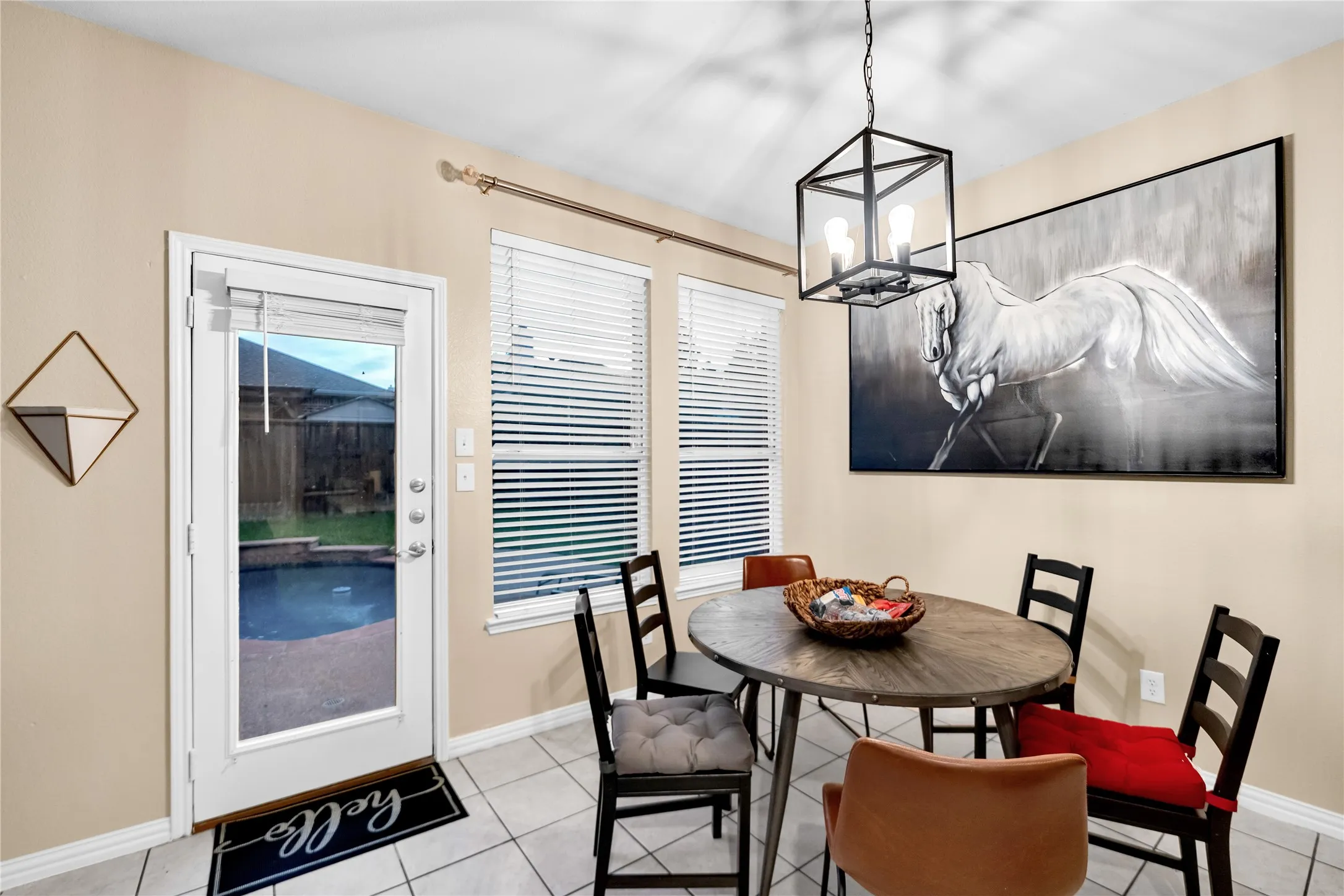 Recessed lighting, tile flooring, and a glass-paneled door