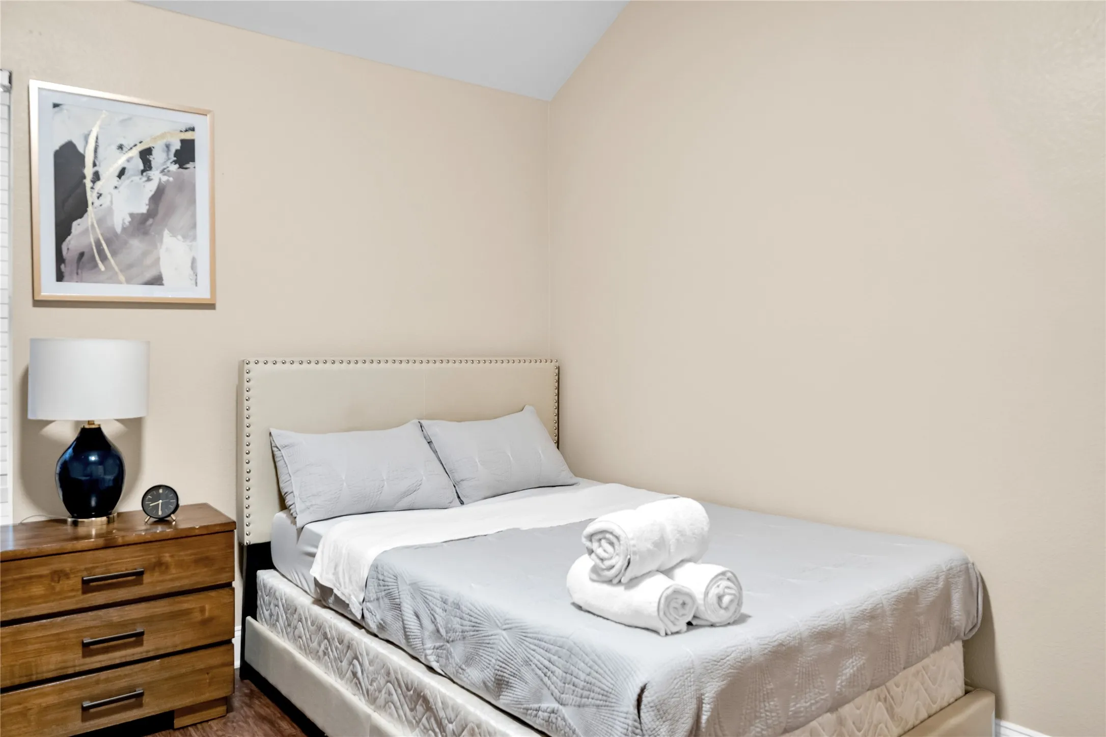Upholstered bed frame with nailhead trim