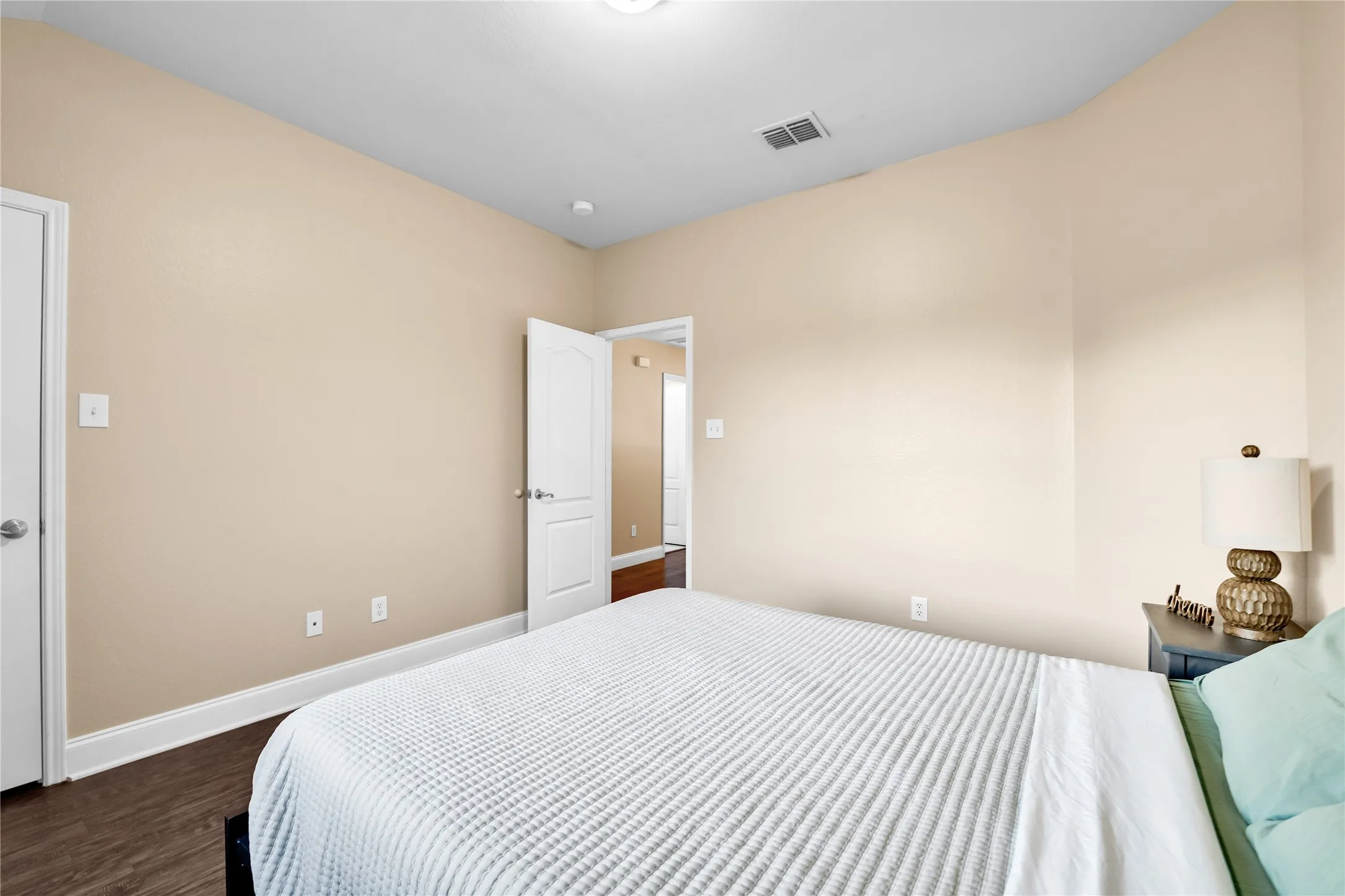 Wood-finish flooring with neutral wall tones and white trim