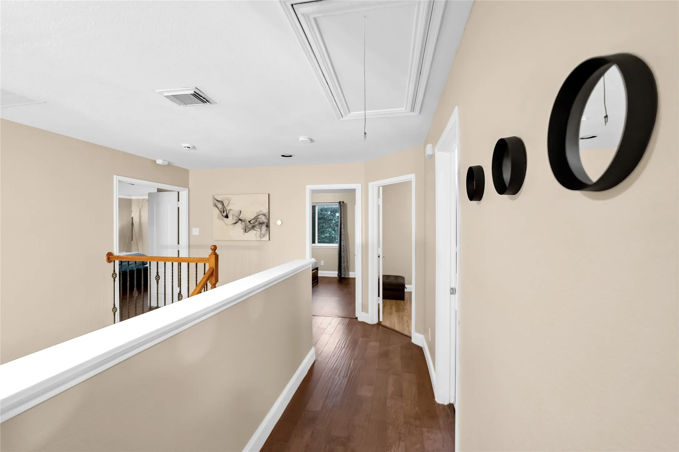 Wood-finish flooring throughout, light neutral wall tones, and white trim