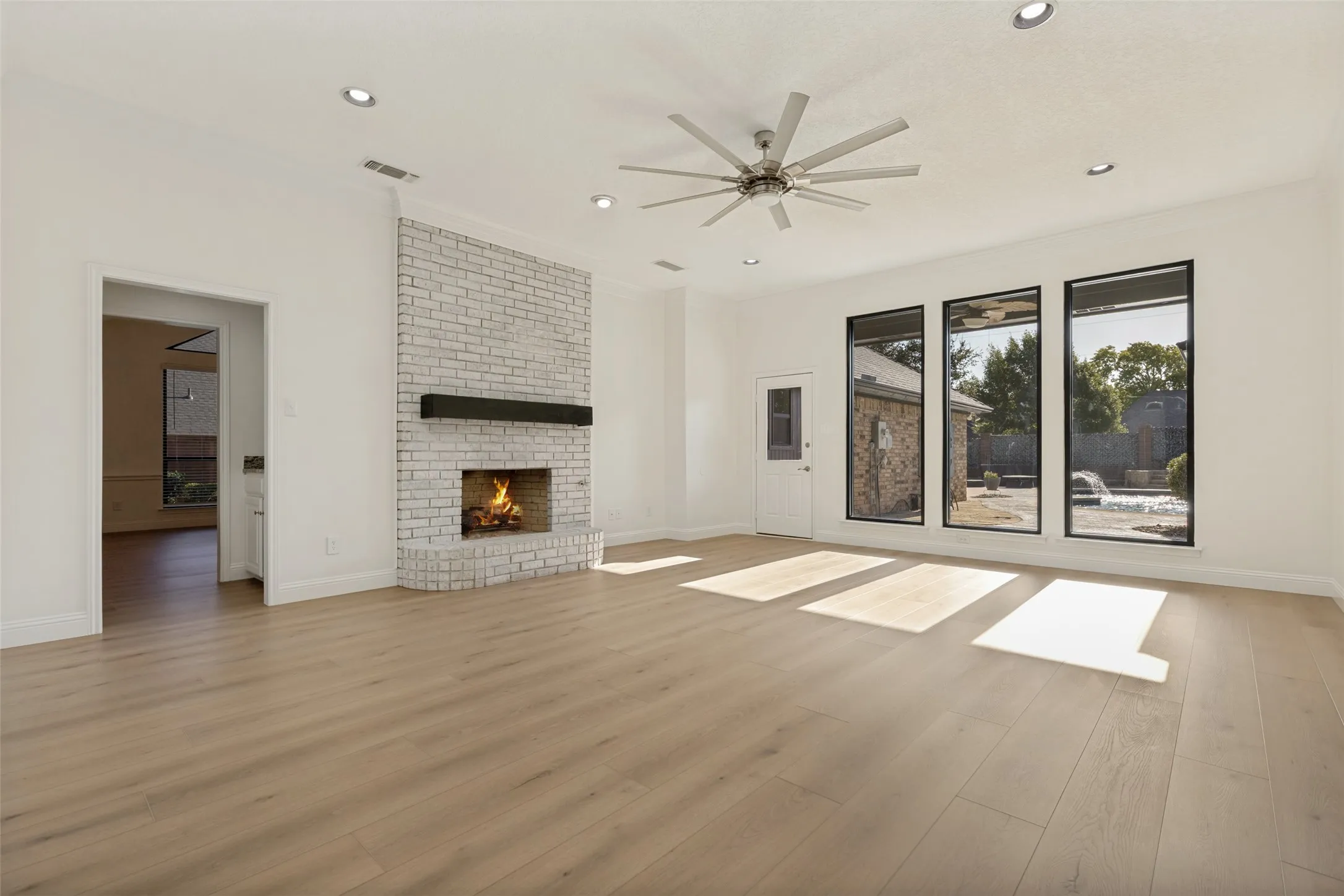 View of Living Room with Fireplace with Gas Logs and Ceiling Fan