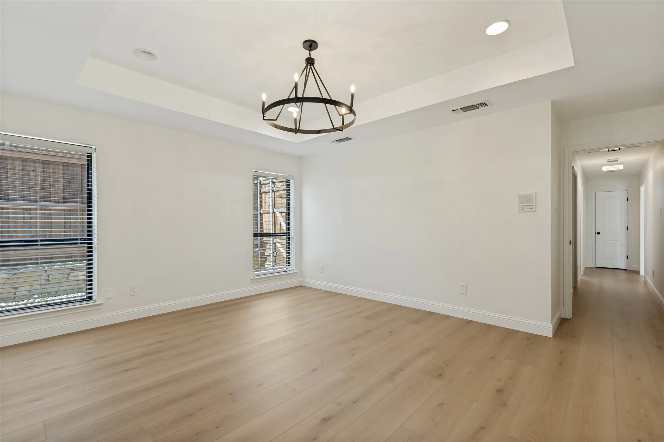 Primary Bedroom with Chandelier, Luxury Vinyl Plank Flooring