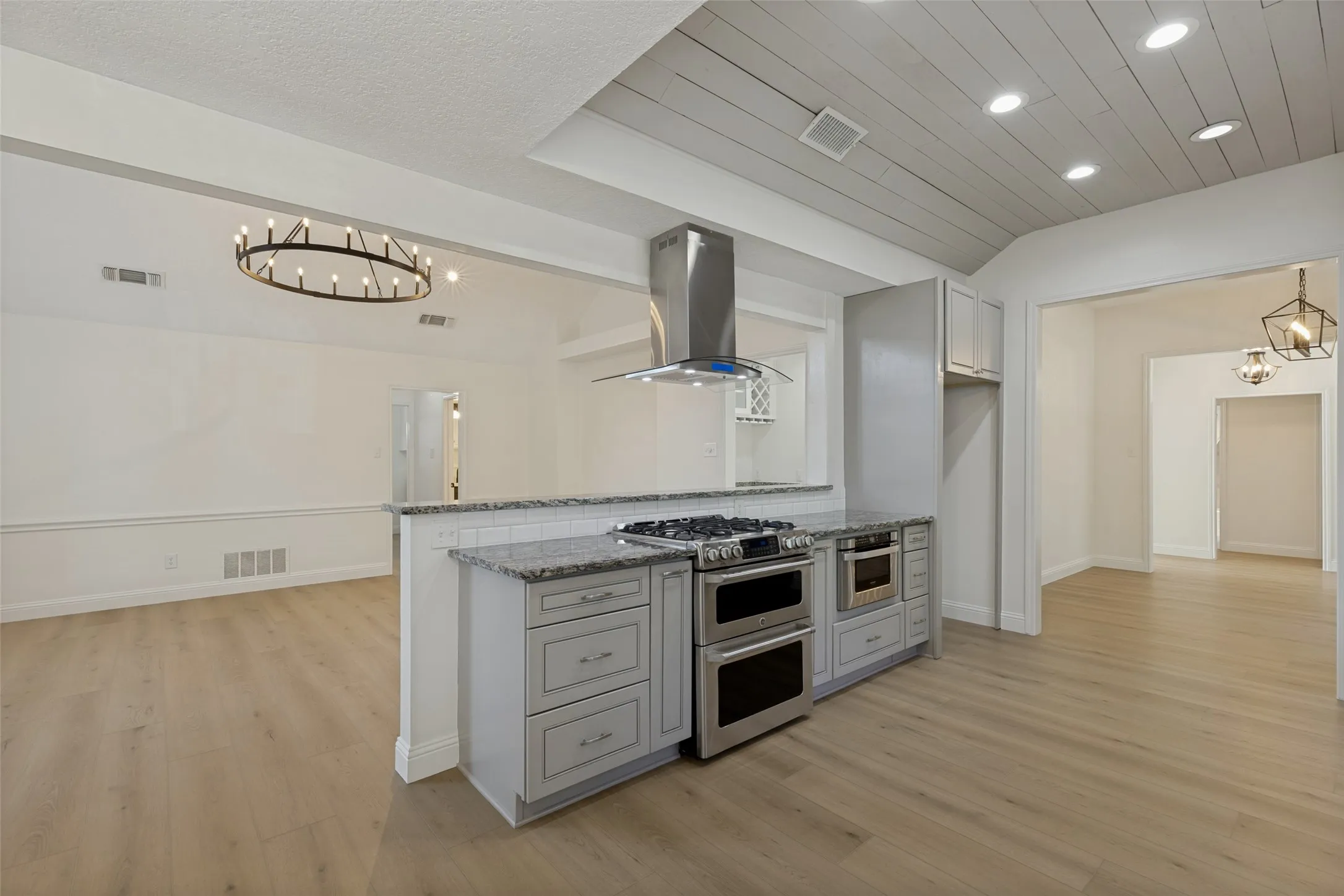 Kitchen showing the Double Ovens. One Oven is Gas and One is an Electric Oven and Gas Burners.