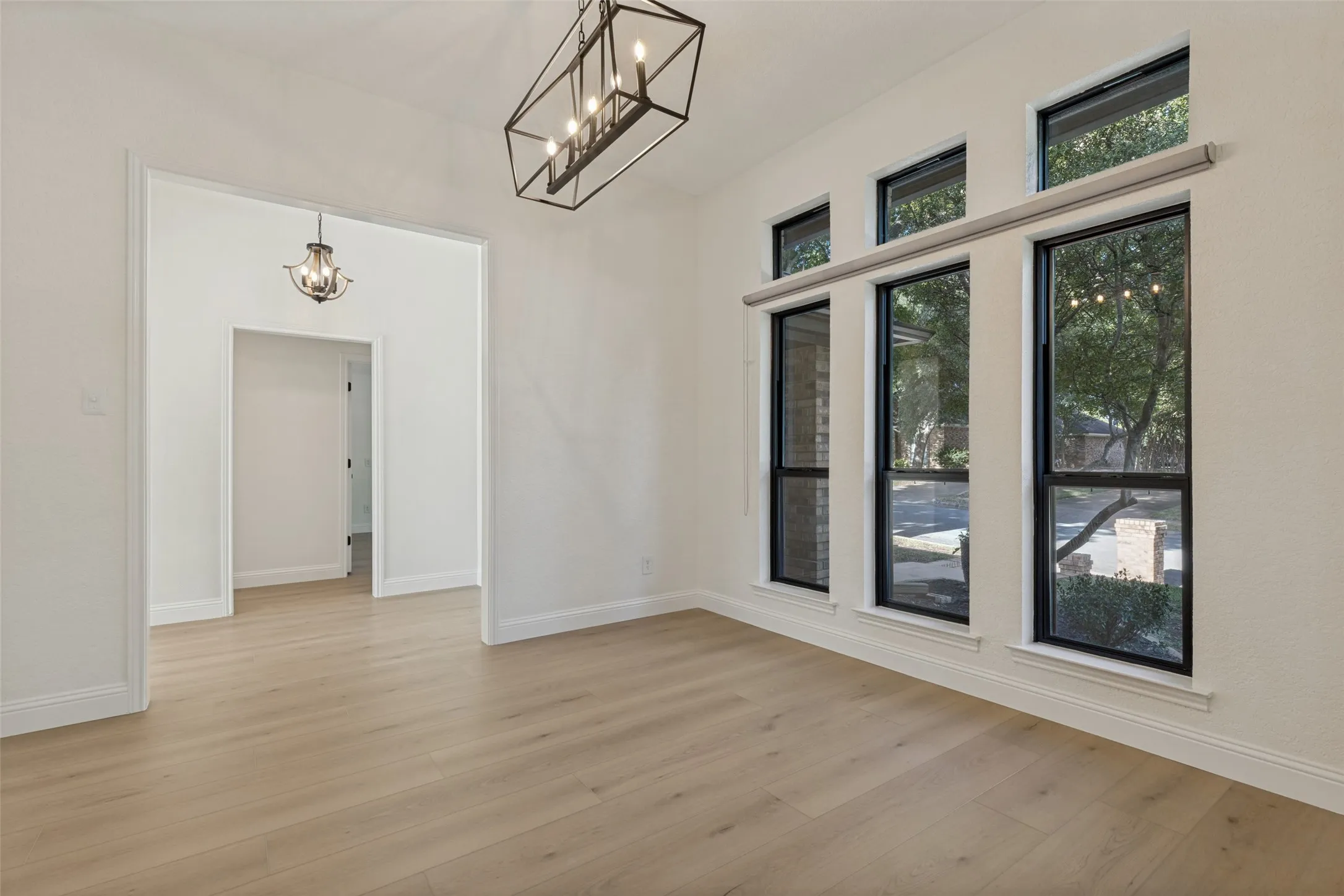 Formal Dining Room with Large Windows to allow Lots of Natural Light and Vinyl Plank Flooring