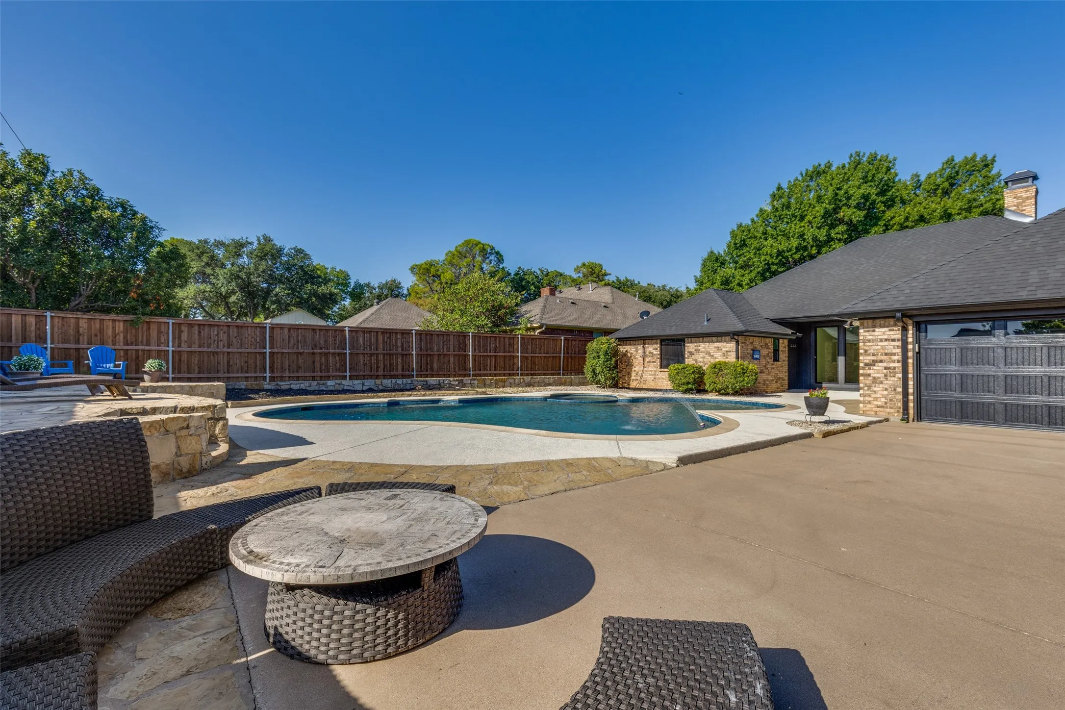 Another View of Back Yard Area showcasing Sitting Area for Parties and shows the Rear Entry Driveway to the Double Car Garage with Insulated Garage Door