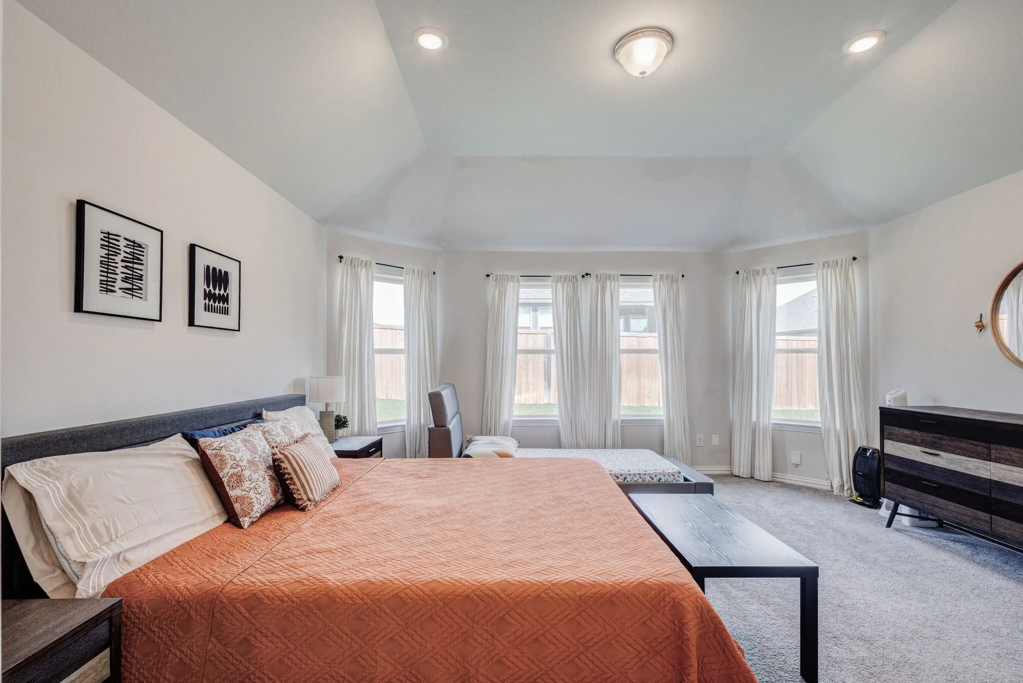 Tray ceiling with recessed lighting and a central fixture