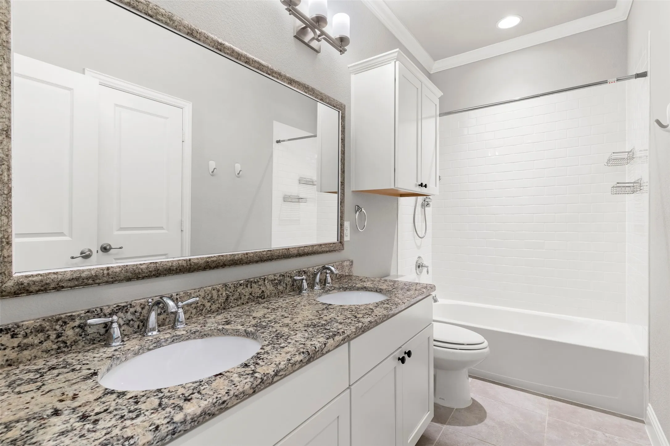Double vanity with undermount sinks and stone-finish countertop