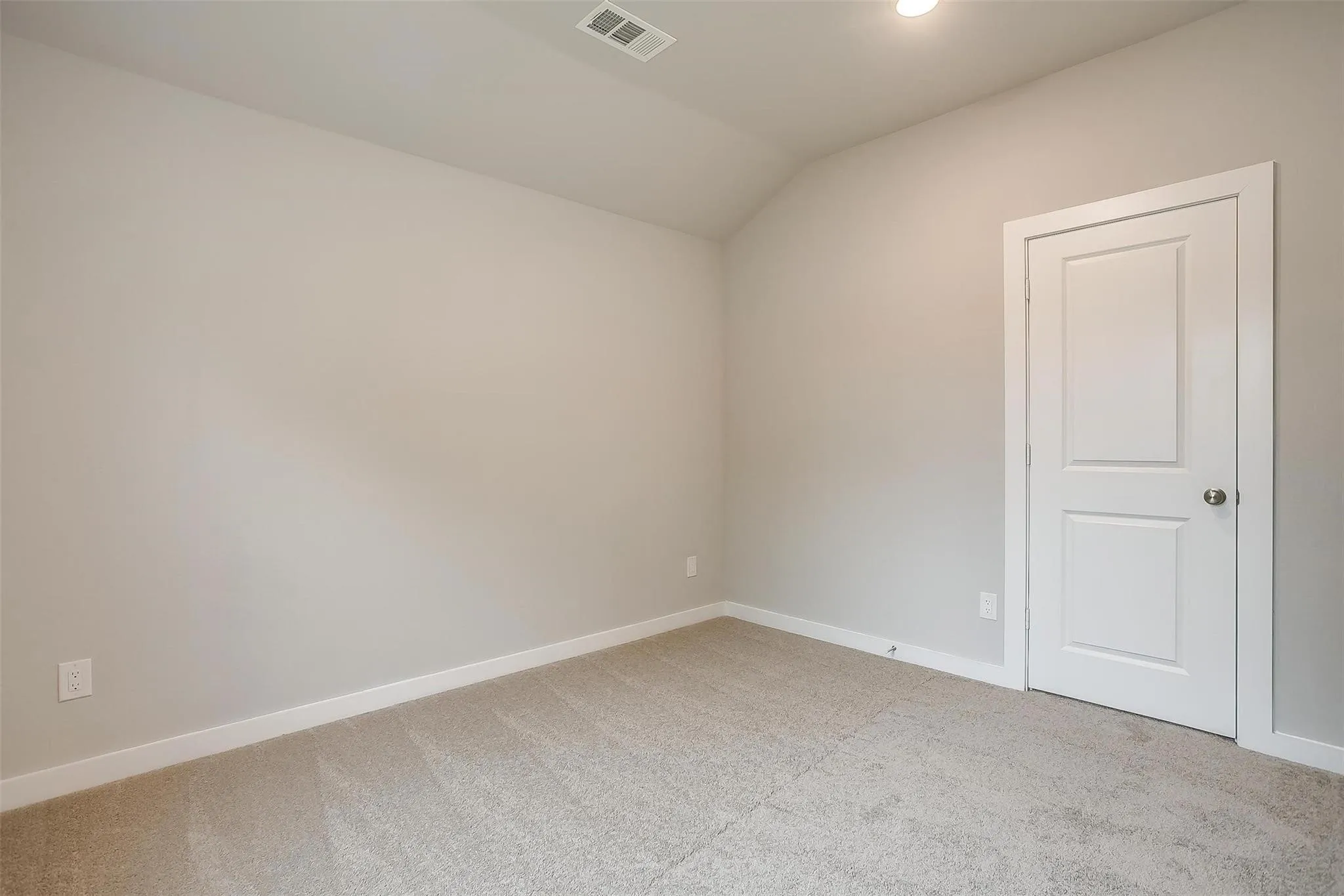 Carpeted flooring, light neutral wall paint, white trim, paneled door, and recessed lighting