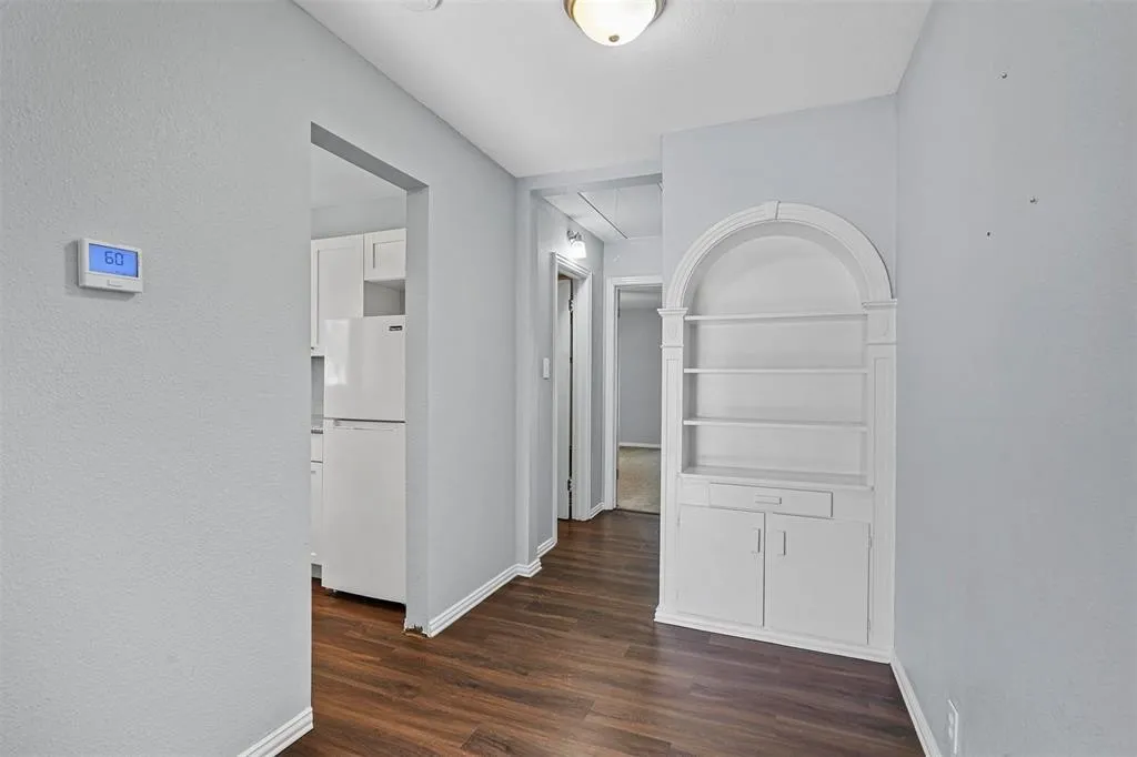Wood-finish flooring throughout, complemented by light gray walls