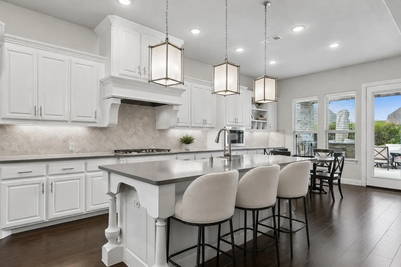 Gourmet Kitchen With Quartz Counters, Double Ovens, And Pendant-Lit Island